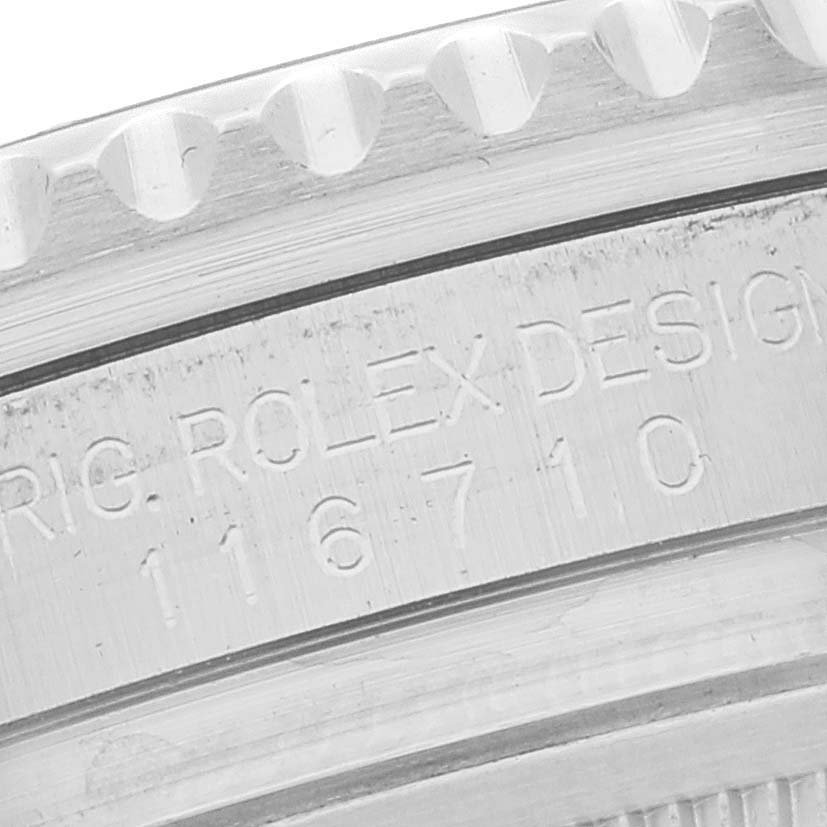 The image shows a close-up view of the engraved bezel and case side of a Rolex GMT-Master 116710 Men
s Stainless Steel Black Dial 116710 Men
s Stainless Steel Black Dial model.