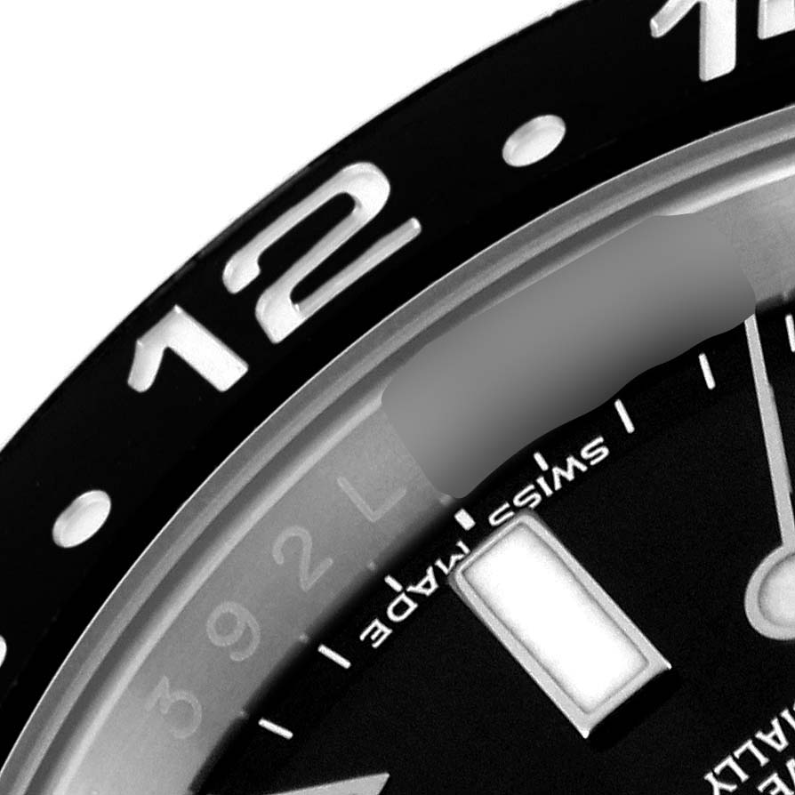 This close-up image shows the bezel and part of the dial of the Rolex GMT-Master 116710 Men
s Stainless Steel Black Dial 116710 Men
s Stainless Steel Black Dial watch.