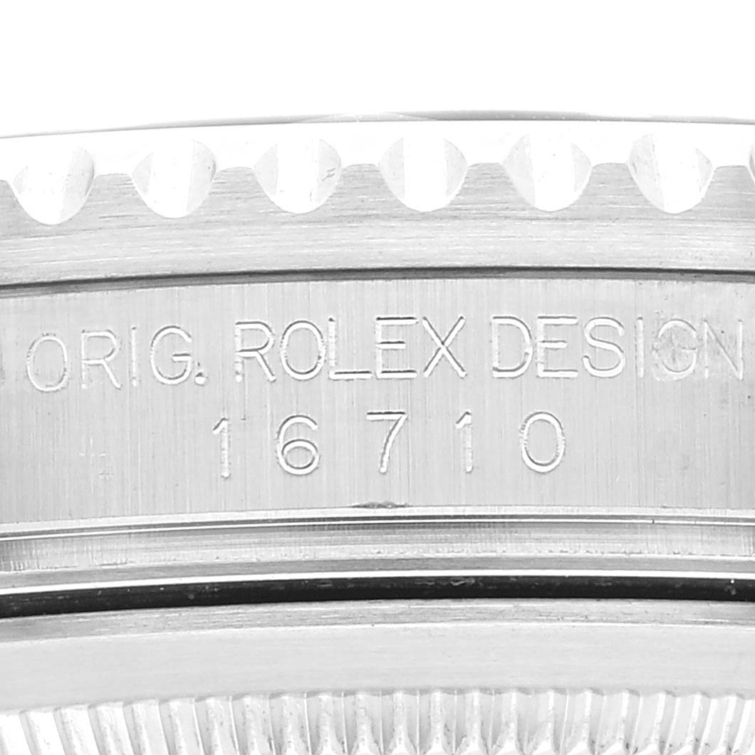 Close-up view of the Rolex GMT-Master 16710 Men
s Stainless Steel Black Dial 16710 Men
s Stainless Steel Black Dial model 16710, showing the engraved bezel and part of the case.