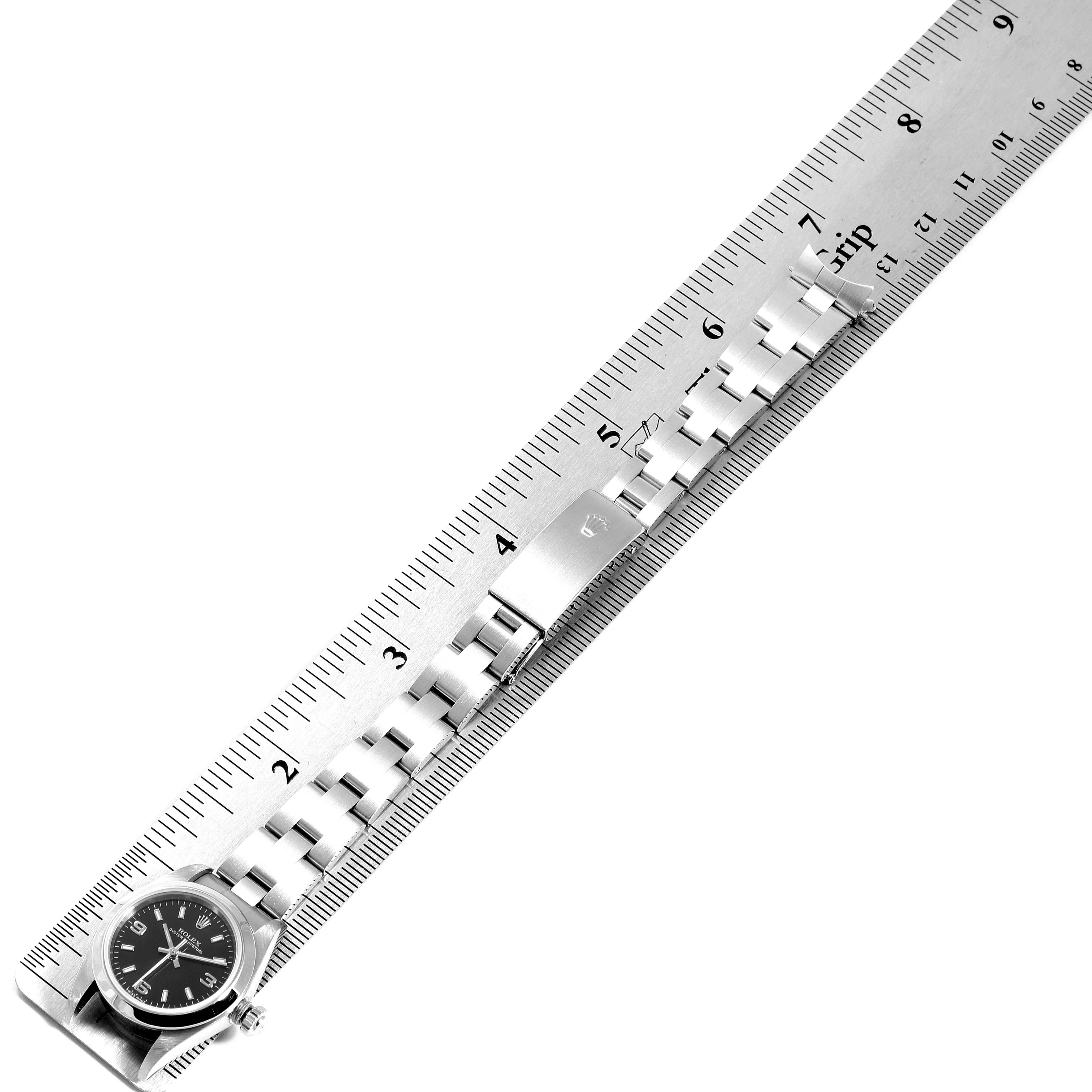The image shows a side view of a Rolex Oyster Perpetual 76080 Women's Stainless Steel Black Dial 76080 Women's Stainless Steel Black Dial watch, focusing on its bracelet and clasp, measured against a ruler.