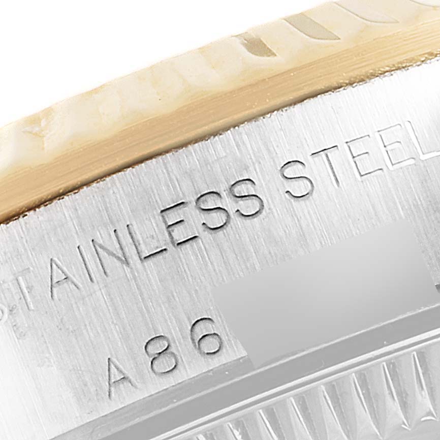 This image shows a close-up of the stainless steel engraving on the bezel and case of a Rolex Oyster Perpetual 76193 Women
s Steel and Gold (two tone) Champagne Dial 76193 Women
s Steel and Gold (two tone) Champagne Dial watch.