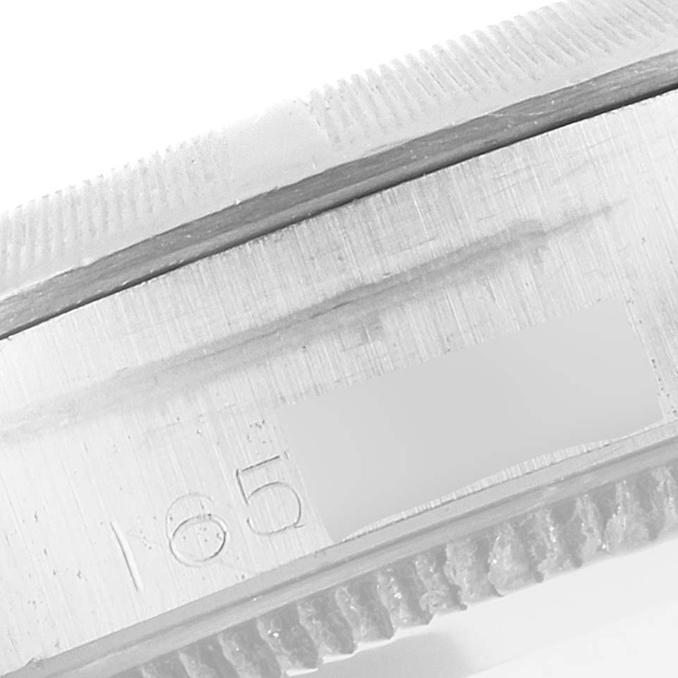 This image shows the edge and serial number of the Rolex Vintage Collection 1003 Men
s Stainless Steel Silver Dial 1003 Men
s Stainless Steel Silver Dial watch from a close-up, side angle.