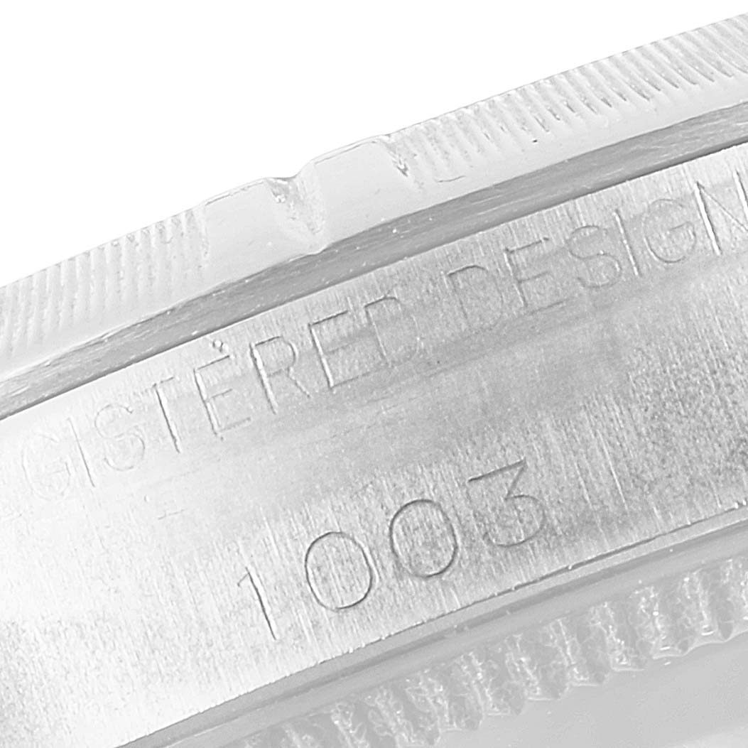 The image shows a close-up angle revealing the engraved serial number and part of the bezel of the Rolex Vintage Collection 1003 Men
s Stainless Steel Silver Dial 1003 Men
s Stainless Steel Silver Dial watch.