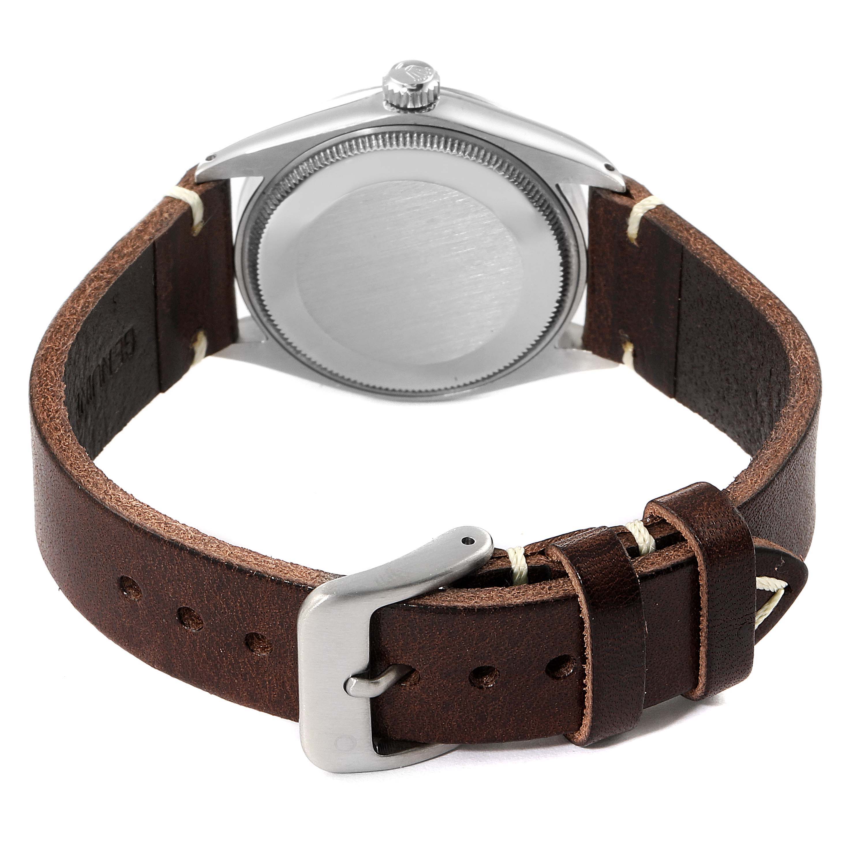 The image shows the back view of a Rolex Vintage Collection 1003 Men
s Stainless Steel Silver Dial 1003 Men
s Stainless Steel Silver Dial watch with a brown leather strap and buckle.