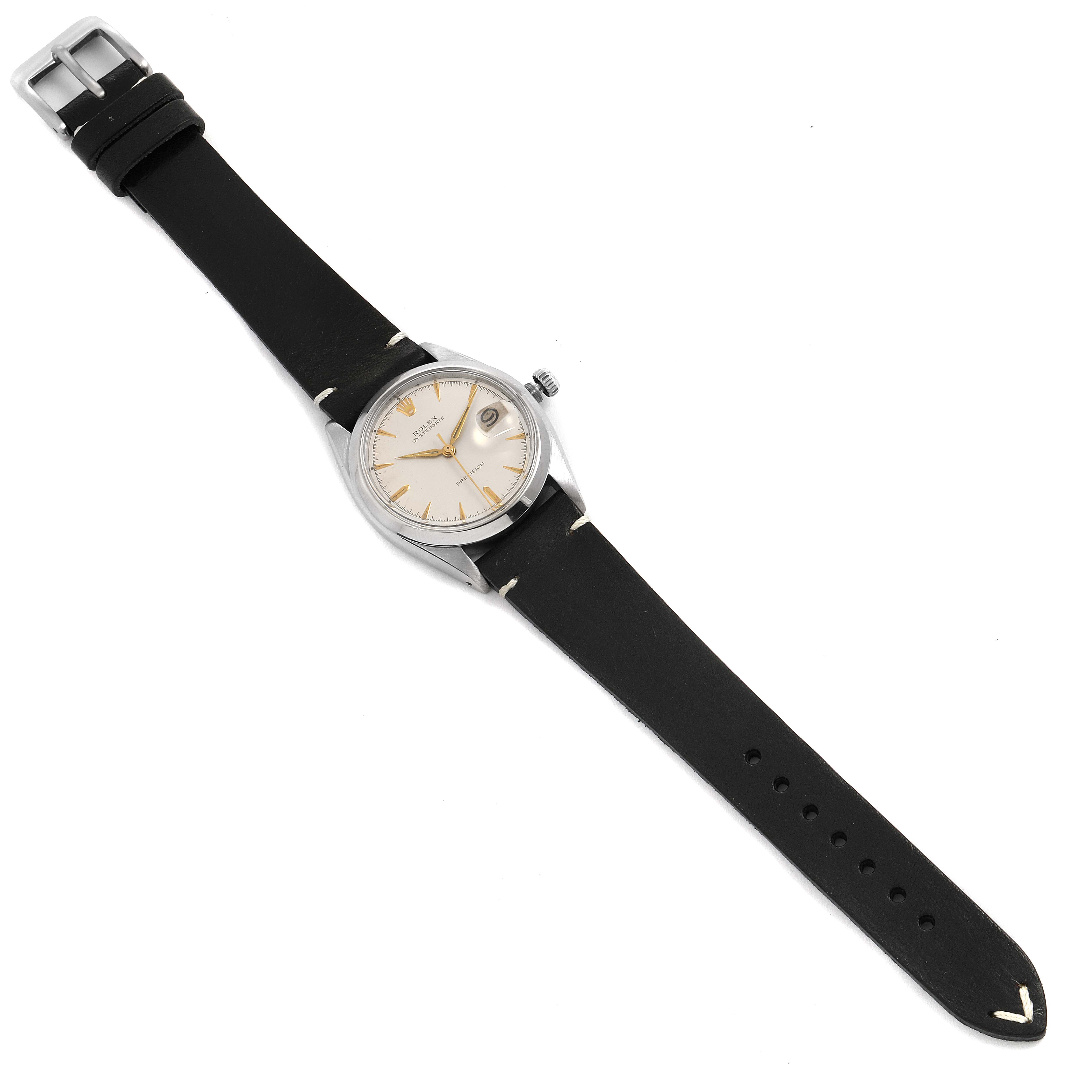 The Rolex Vintage Collection 6694 Men
s Stainless Steel Silver Dial 6694 Men
s Stainless Steel Silver Dial model watch is shown from a top-down angle, displaying its face, case, crown, and black leather strap.