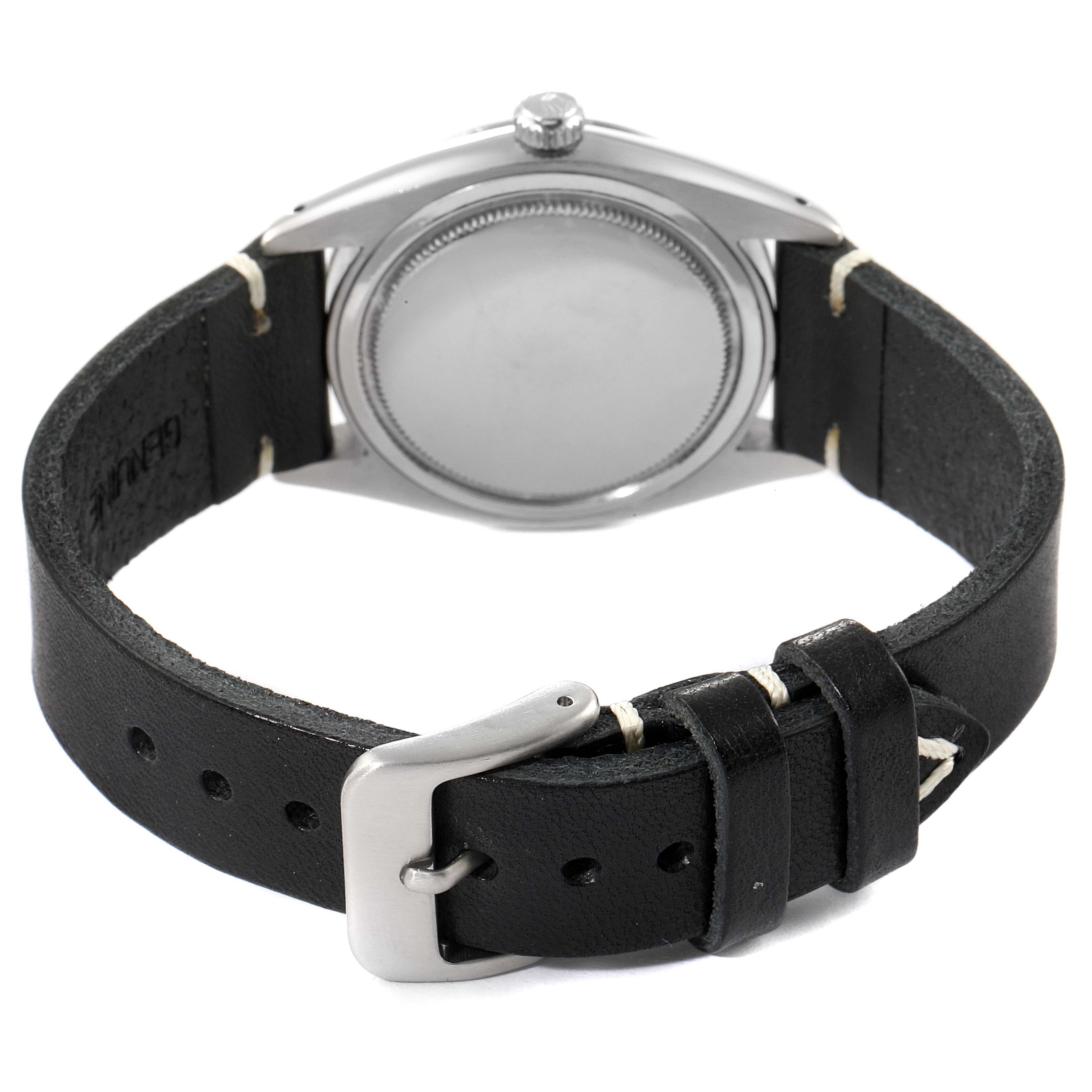 This image shows the back view of a Vintage Collection Rolex watch, highlighting the case back and the black leather strap with buckle.