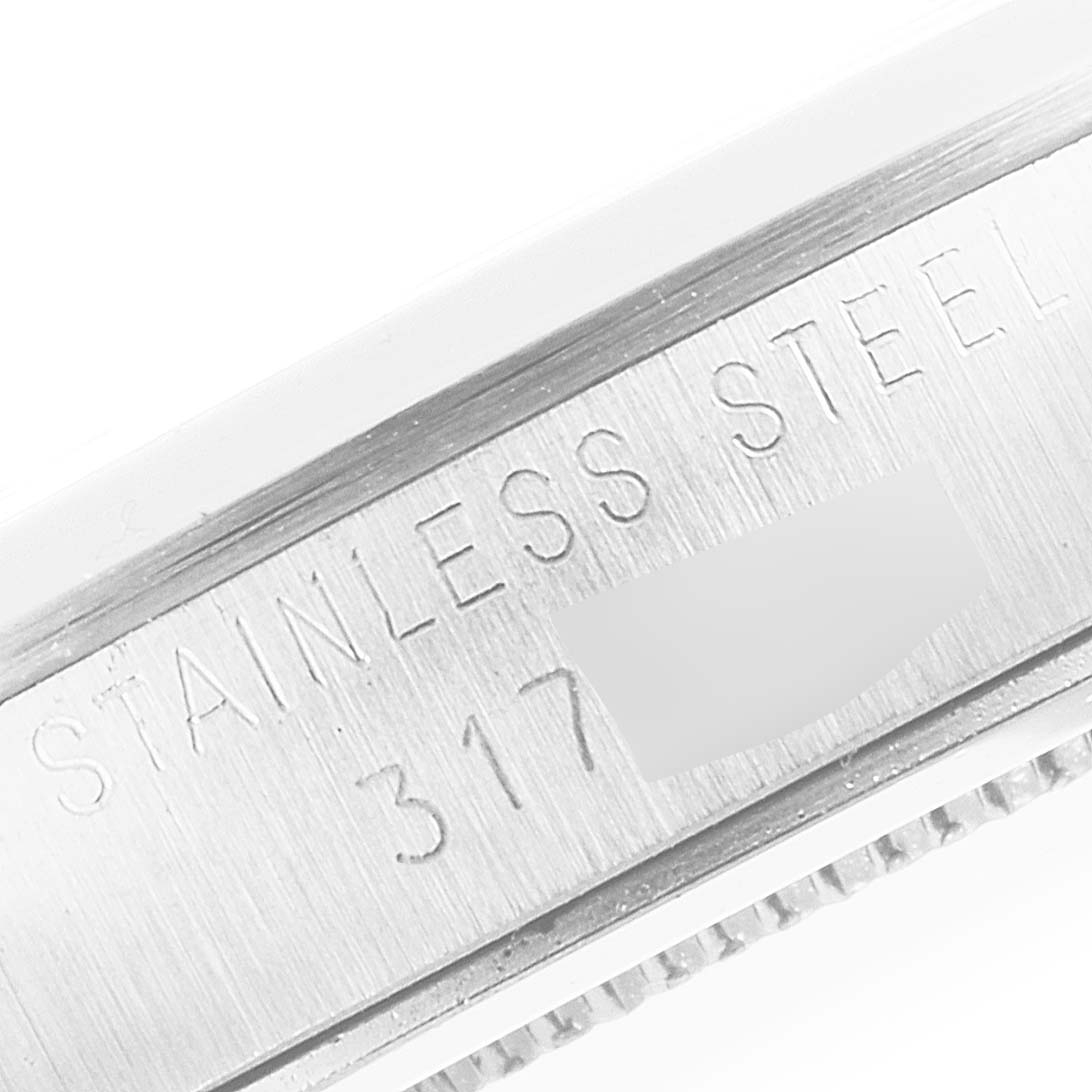 The image shows a close-up of the side inscription on the bezel of the Rolex Vintage Collection 6426 Men's Stainless Steel Silver Dial 6426 Men's Stainless Steel Silver Dial model, highlighting "STAINLESS STEEL" and "317."