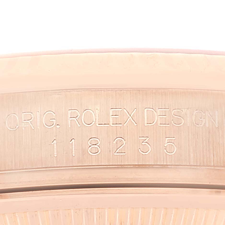 This image shows the side view of a Rolex President 118235 Men's Rose Gold Pink Dial 118235 Men's Rose Gold Pink Dial model watch, focusing on its engraved serial number and design details.