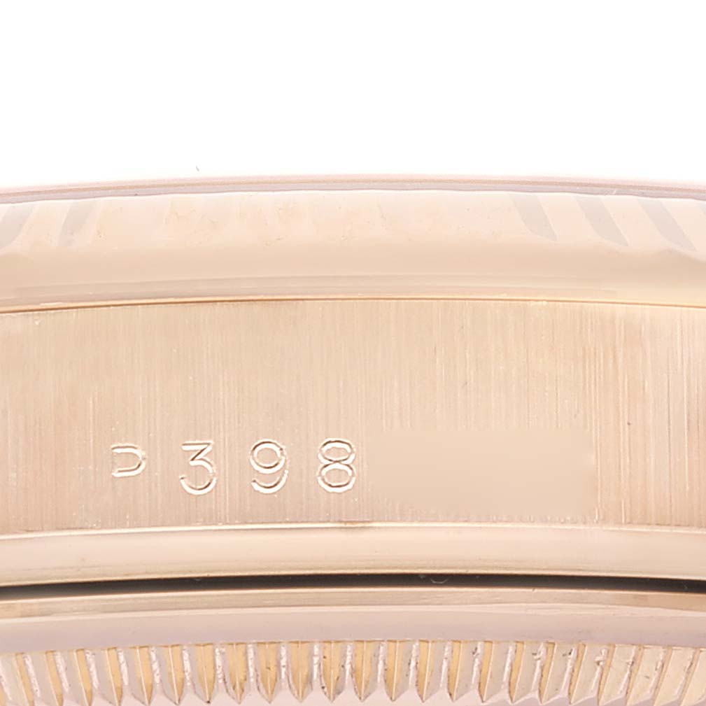 This image shows a close-up, side view of the casing with serial number engraving on a Rolex President 118235 Men's Rose Gold Pink Dial 118235 Men's Rose Gold Pink Dial model watch.