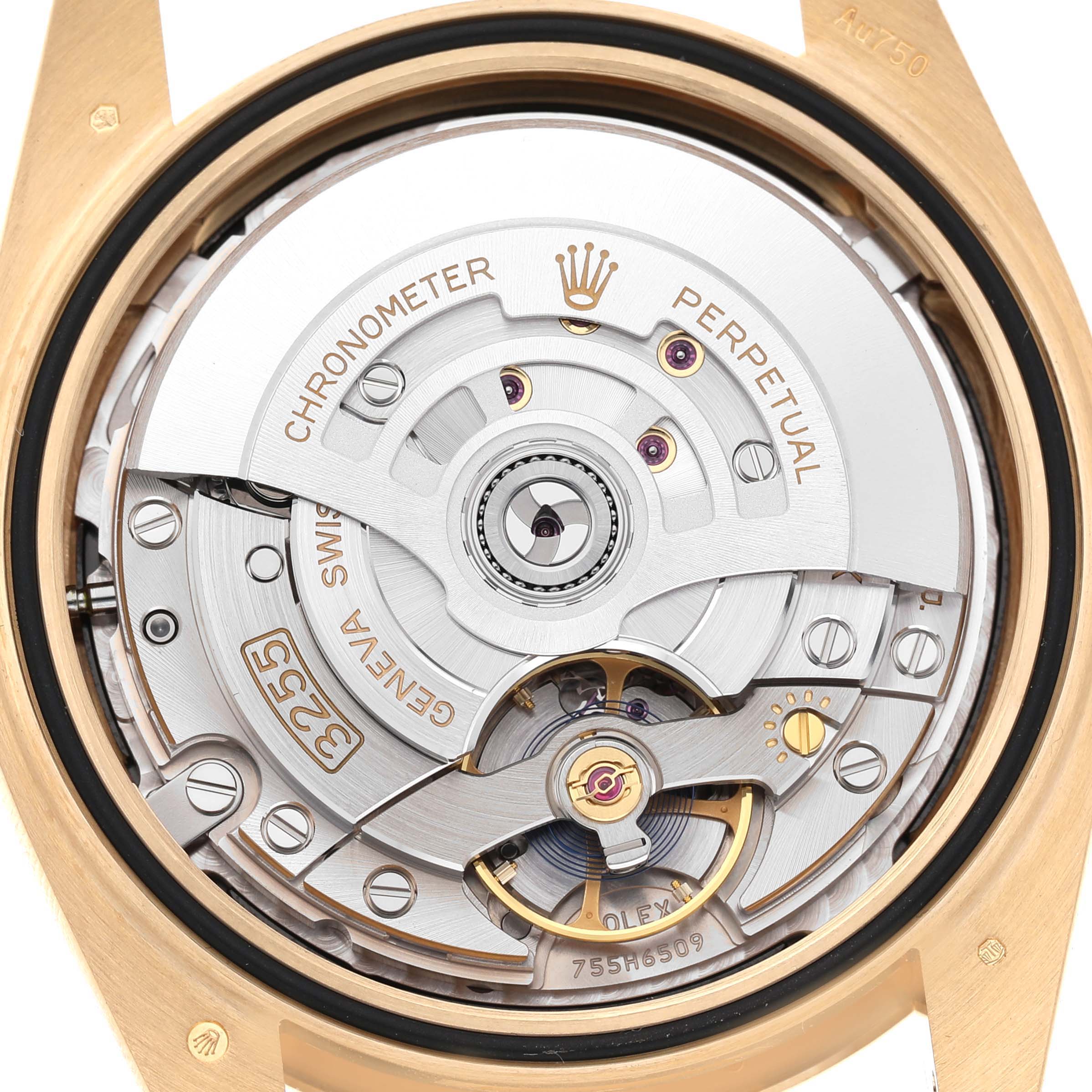 The image shows the back view of a Rolex President 228238 Men's Yellow Gold Black Dial model, highlighting its intricate movement and rotor.