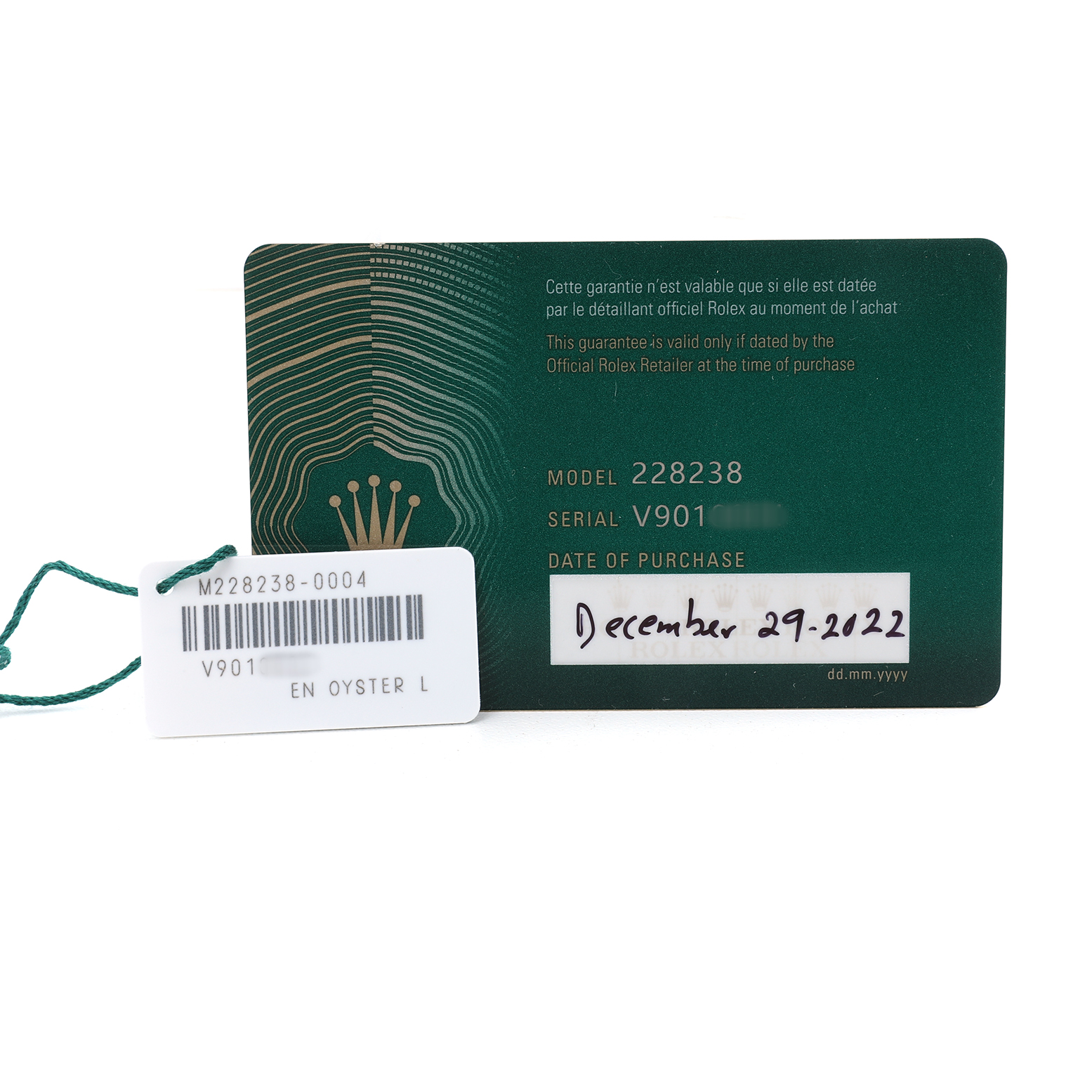 The image shows a green Rolex guarantee card and a tag with details for the President model.
