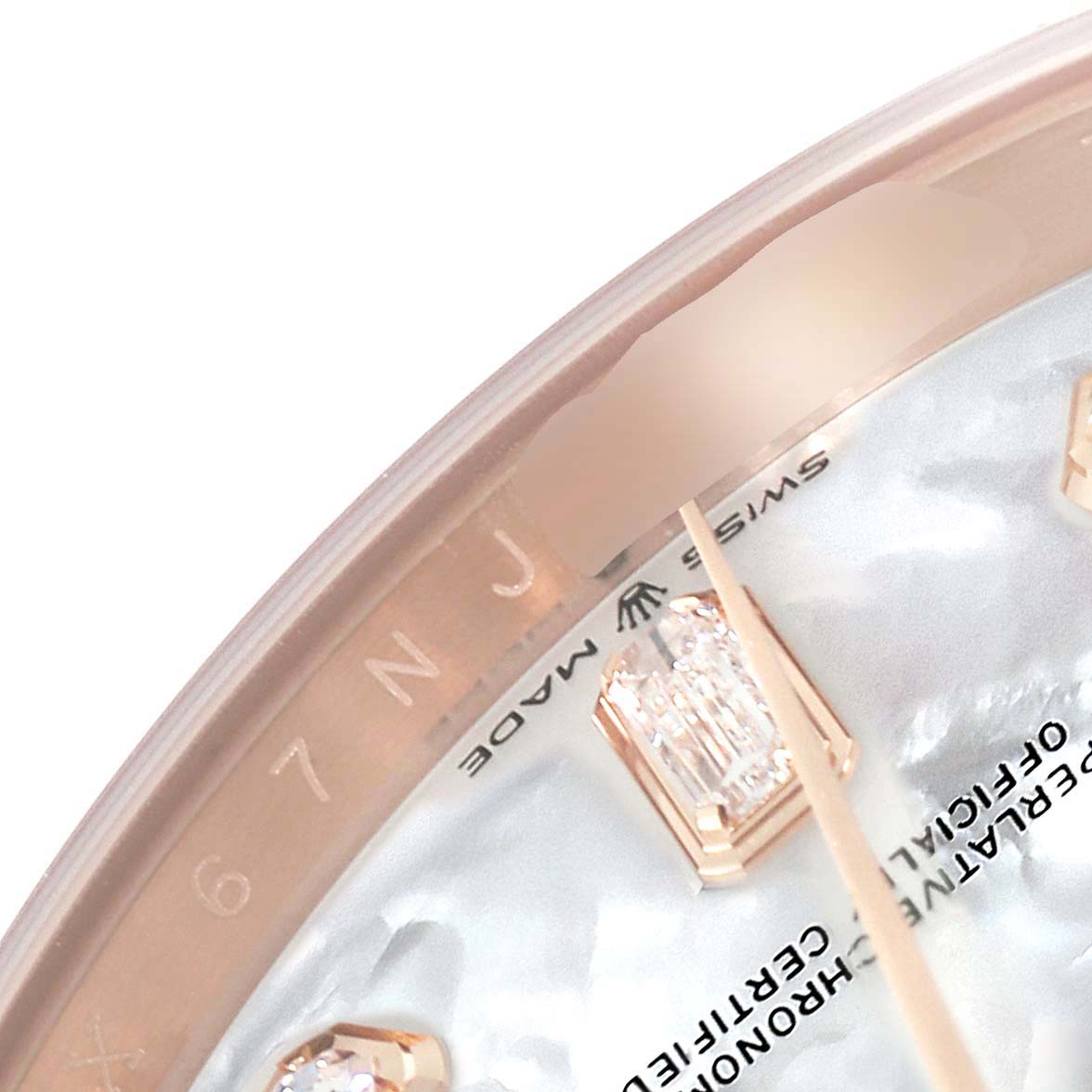 This close-up of the Rolex President 128235 Men's Rose Gold Mother of Pearl Dial 128235 Men's Rose Gold Mother of Pearl Dial model shows the upper part of the dial, markers, and the "Swiss Made" text.