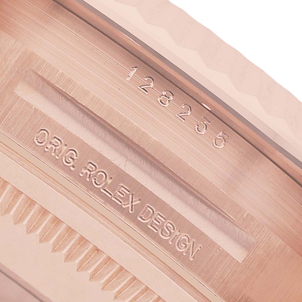 The image shows a close-up of the side and edge of the case of a Rolex President 128235 Men's Rose Gold Mother of Pearl Dial model, highlighting the engraved model and design details.