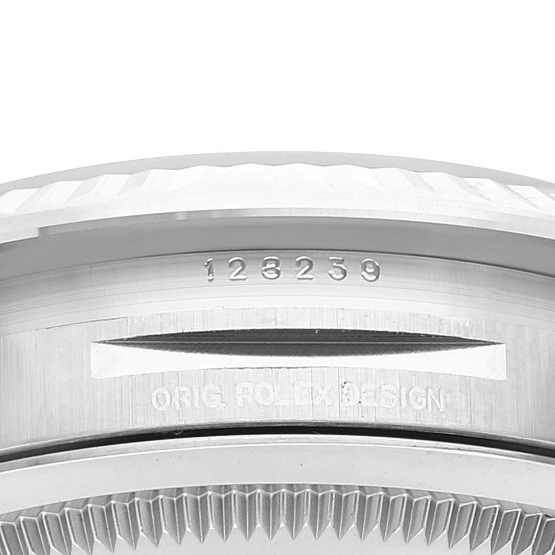 This image shows an angled close-up of the case and bezel of a Rolex President 128239 Men's White Gold Blue Dial 128239 Men's White Gold Blue Dial model, highlighting serial engravings.