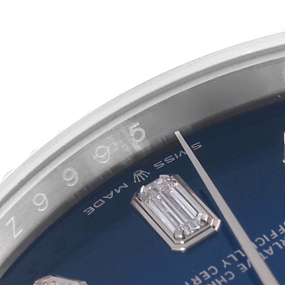 This close-up image shows a portion of the dial and bezel of a Rolex President 128239 Men's White Gold Blue Dial 128239 Men's White Gold Blue Dial model watch.