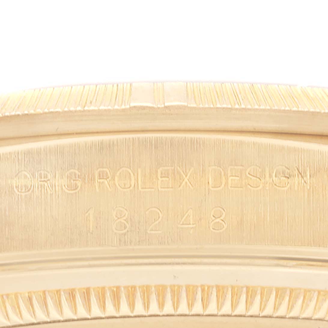 This image shows a close-up of the side of a Rolex President 18248 Men
s Yellow Gold Champagne Dial 18248 Men
s Yellow Gold Champagne Dial model, highlighting the engraved watch serial number and design details.