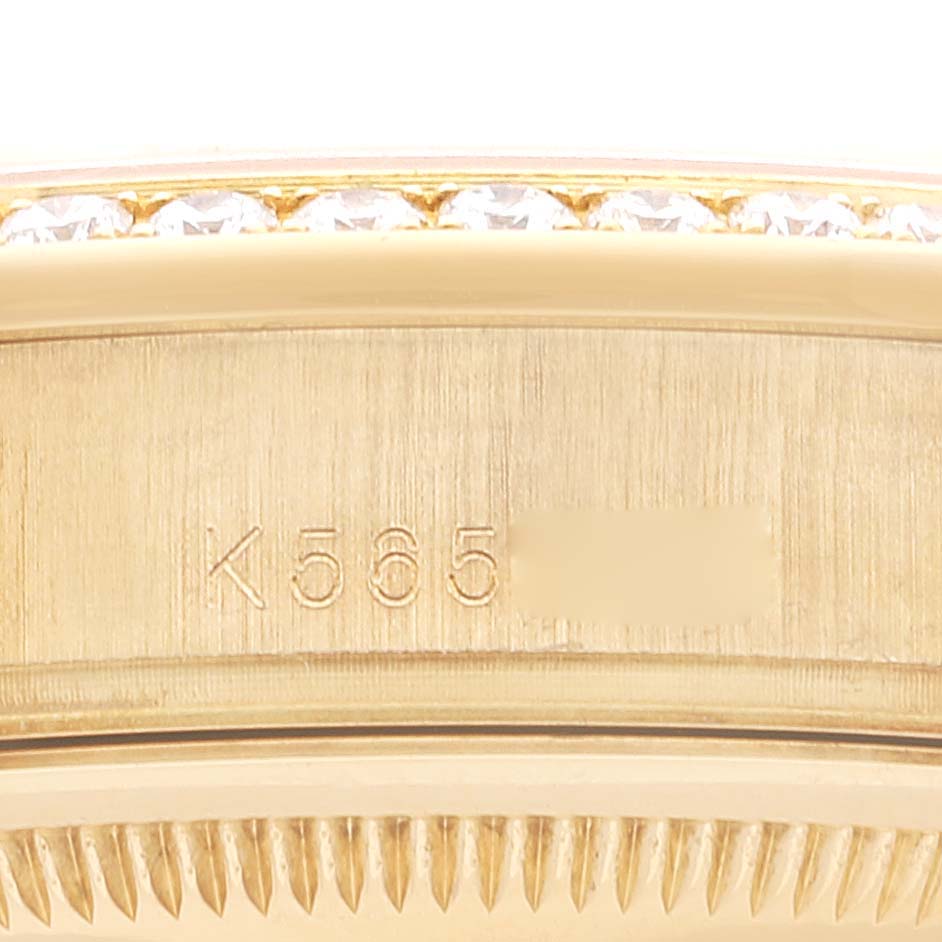 The image shows a close-up angle of the side of a Rolex President 118348 Men
s Yellow Gold Silver Dial 118348 Men
s Yellow Gold Silver Dial model watch, emphasizing the serial number and part of the bezel.