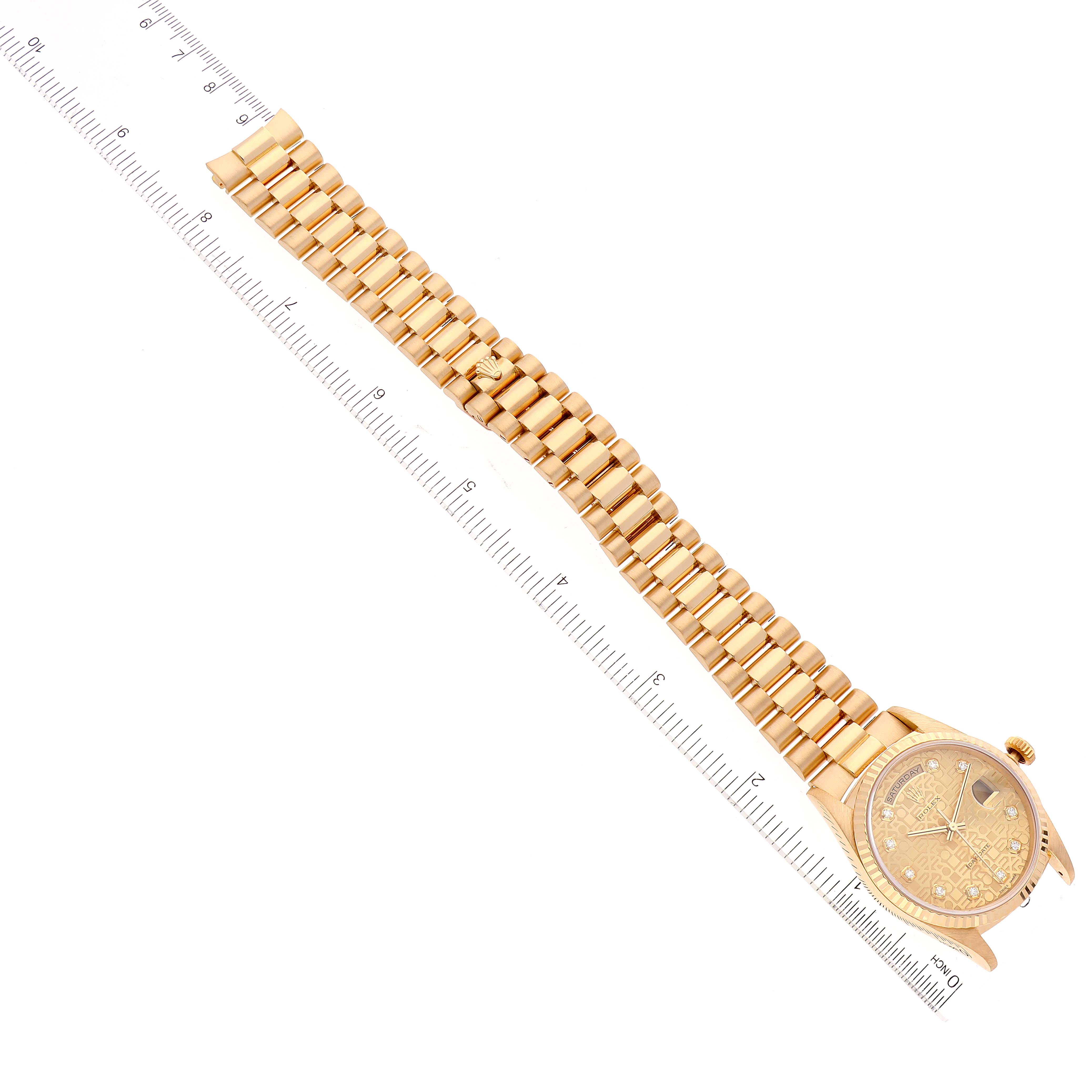 The Rolex President 18238 Men
s Yellow Gold Champagne Dial 18238 Men
s Yellow Gold Champagne Dial watch is shown at a top-down angle, displaying the face, bezel, case, bracelet, and a ruler for scale.