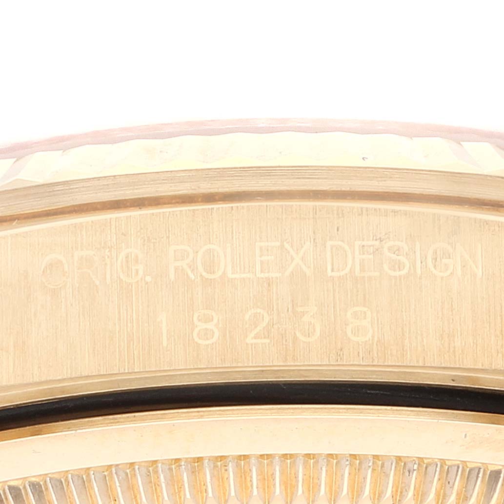 This close-up image shows the engraved side of a Rolex President 18238 Men
s Yellow Gold Champagne Dial 18238 Men
s Yellow Gold Champagne Dial model, highlighting the serial number and the "ORIG. ROLEX DESIGN" text.