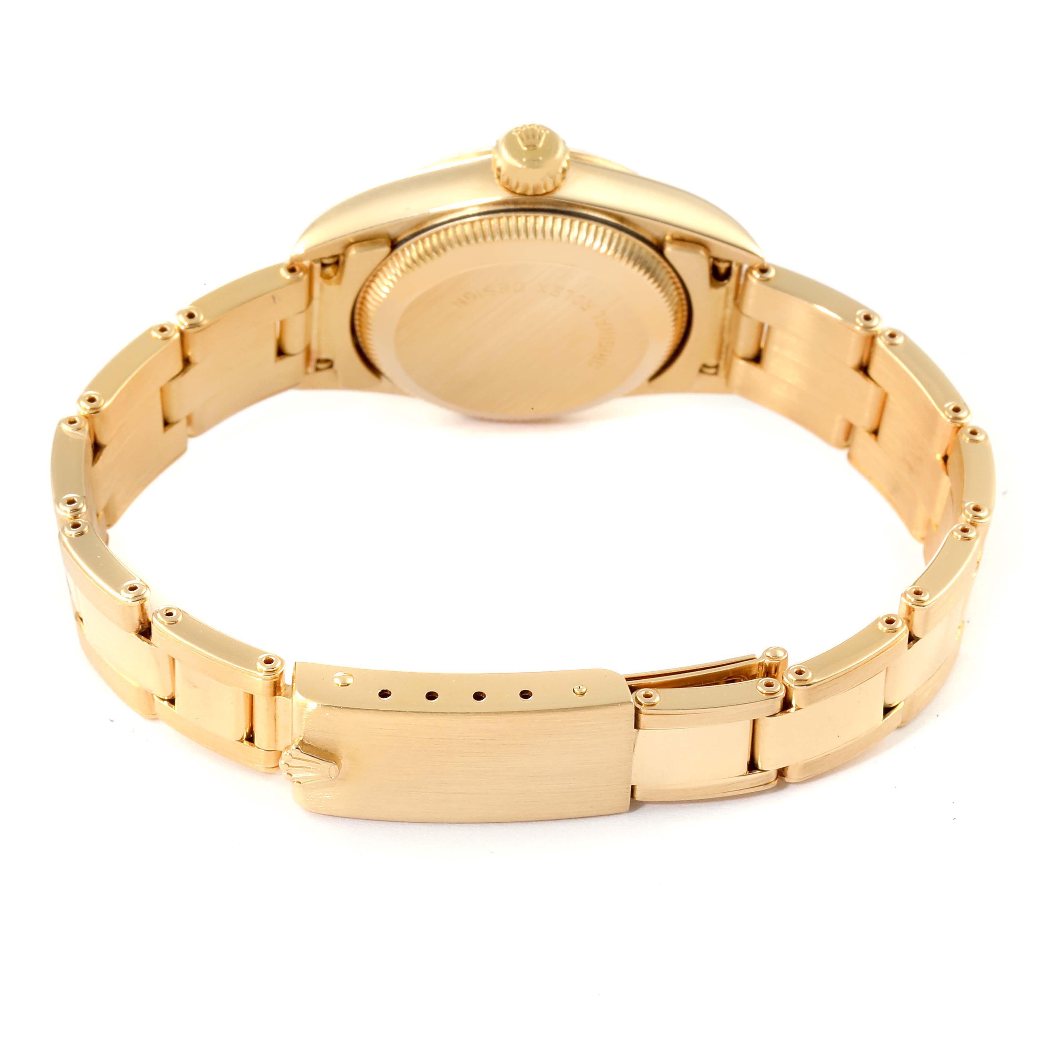 The image shows the back view of a Rolex President 67198 Women
s Yellow Gold Champagne Dial 67198 Women
s Yellow Gold Champagne Dial model watch, highlighting the gold bracelet and clasp.
