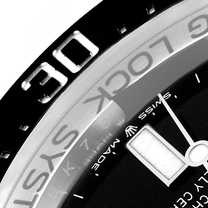 The image shows a close-up of the bezel and part of the dial of a Rolex Sea-Dweller 136660 Men
s Stainless Steel Blue Dial 136660 Men
s Stainless Steel Blue Dial watch, highlighting the "30" marker and some text.