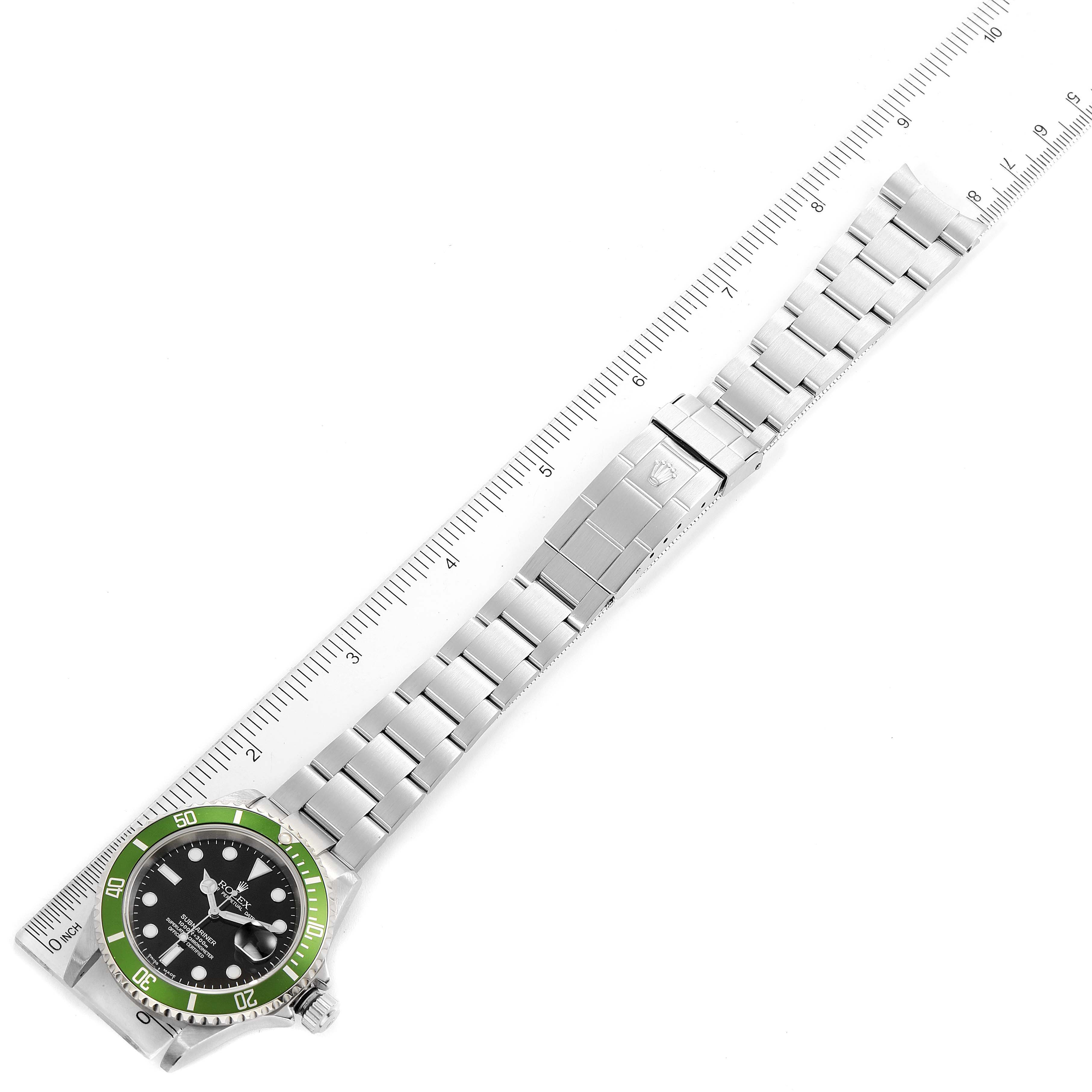 The image shows a top-down view of a Rolex Submariner 16610LV Men
s Stainless Steel Black Dial 16610LV Men
s Stainless Steel Black Dial watch, displaying the face, bezel, and bracelet along with a ruler for scale.
