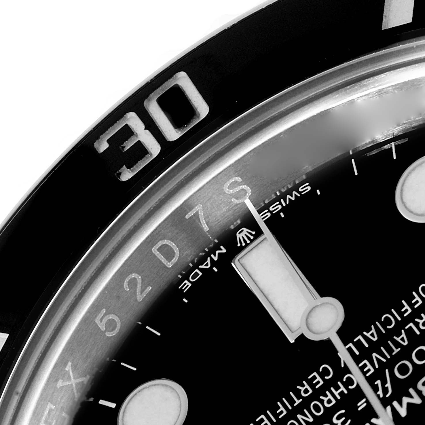 The image shows a close-up view of the Rolex Submariner 124060 Men
s Stainless Steel Black Dial 124060 Men
s Stainless Steel Black Dial
s bezel and part of its dial, highlighting the 30-minute mark.