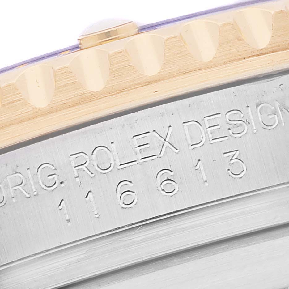 The image shows a close-up of the side of a Rolex Submariner 116613 Men's Steel and Gold (two tone) Blue Dial 116613 Men's Steel and Gold (two tone) Blue Dial, including its bezel and engraved model number.