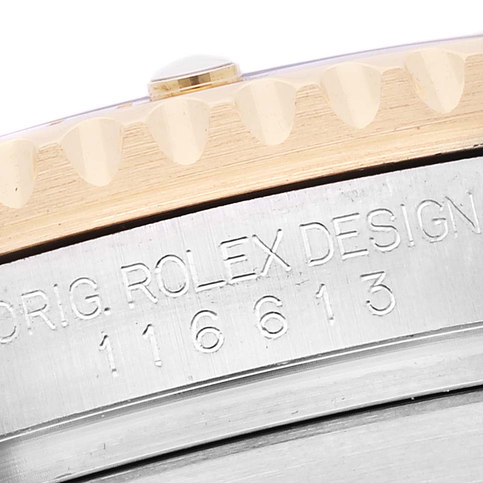 This image shows a close-up of the engraved model number and part of the bezel of a Rolex Submariner 116613 Men's Steel and Gold (two tone) Blue Dial 116613 Men's Steel and Gold (two tone) Blue Dial watch.