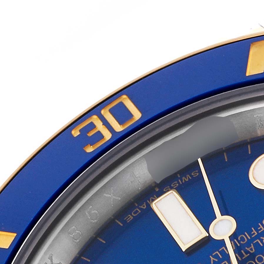 This image shows a close-up of the bezel and part of the dial of a Rolex Submariner 116613 Men's Steel and Gold (two tone) Blue Dial 116613 Men's Steel and Gold (two tone) Blue Dial watch, highlighting the 30-minute mark.