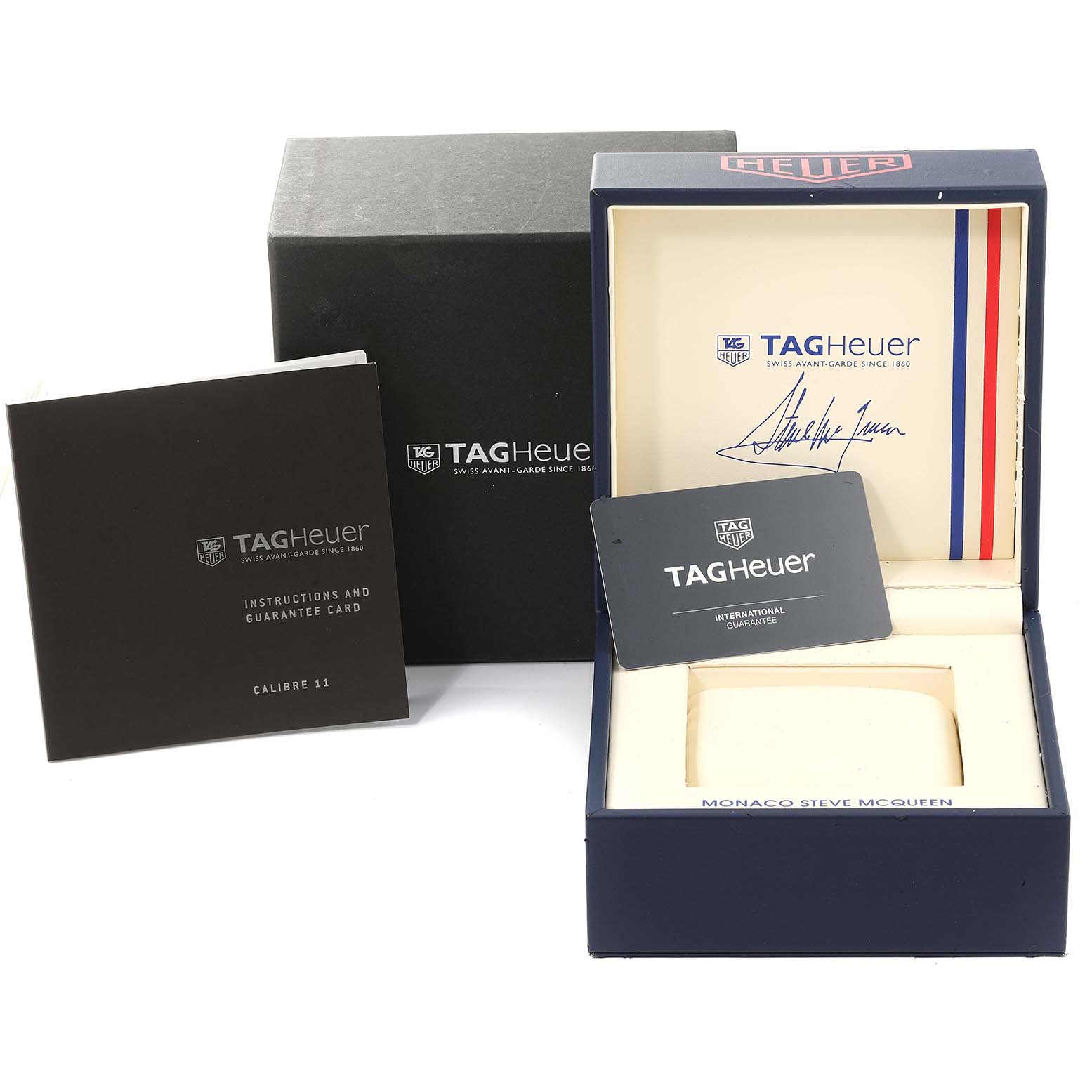 The image shows the packaging and accessories of a Tag Heuer Monaco CAW211P Men's Stainless Steel Blue Dial CAW211P Men's Stainless Steel Blue Dial watch, including the box, instructions, and guarantee card.
