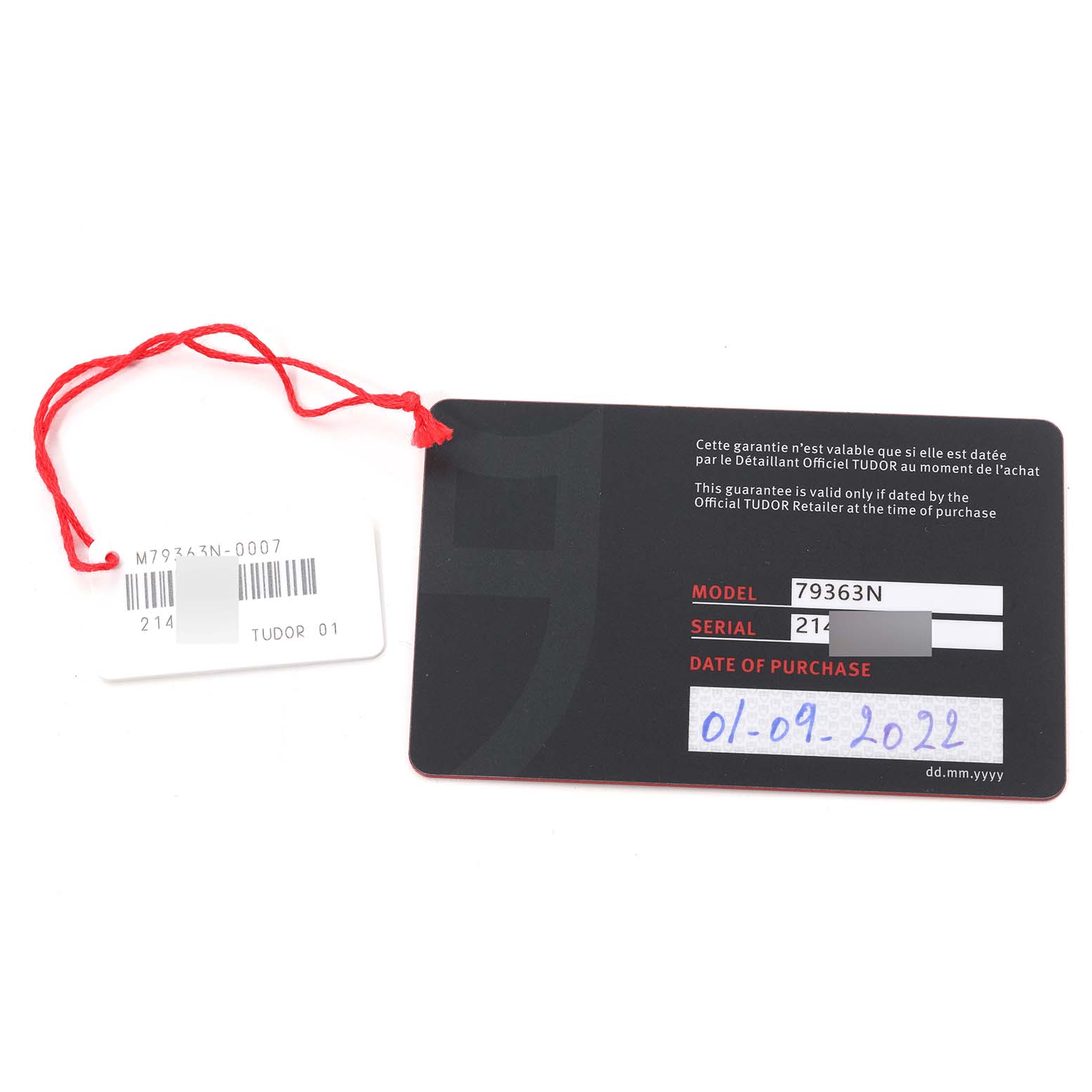 The image shows a warranty card and a tag for the Tudor Heritage Black Bay 79363 Men's Steel and Gold (two tone) Champagne Dial 79363 Men's Steel and Gold (two tone) Champagne Dial model 79363N.