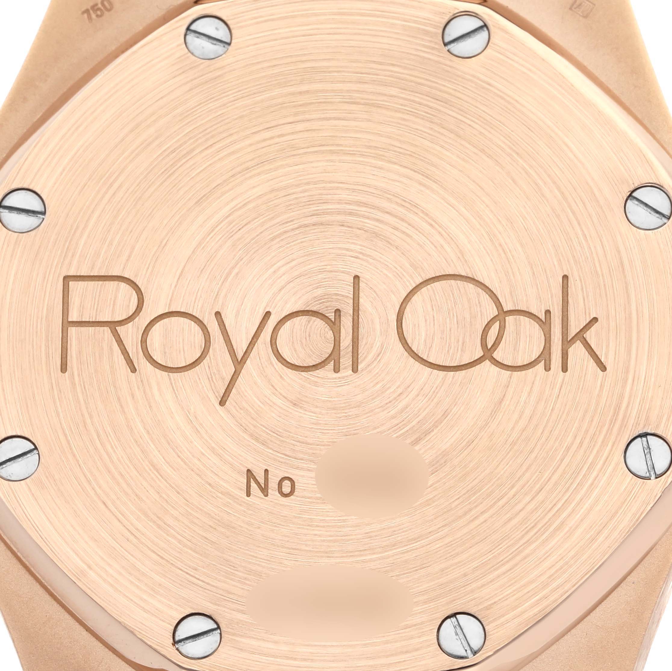 Close-up view of the back case of the Audemars Piguet Royal Oak 26022OR.OO.D088CR.01 Men's Rose Gold Silver Dial 26022OR.OO.D088CR.01 Men's Rose Gold Silver Dial watch showing screws and "Royal Oak" engraving.