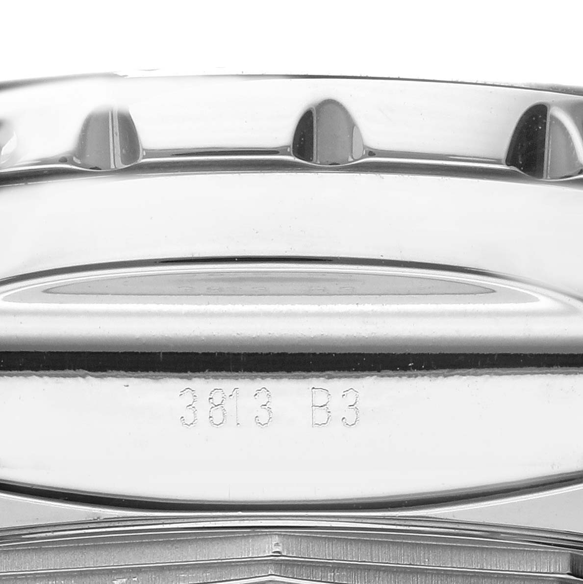 This image shows a close-up of the side of the bezel and case back of a Breitling Bentley AB061112/BC42 Men's Stainless Steel Black Dial AB061112/BC42 Men's Stainless Steel Black Dial model watch, highlighting the serial number.