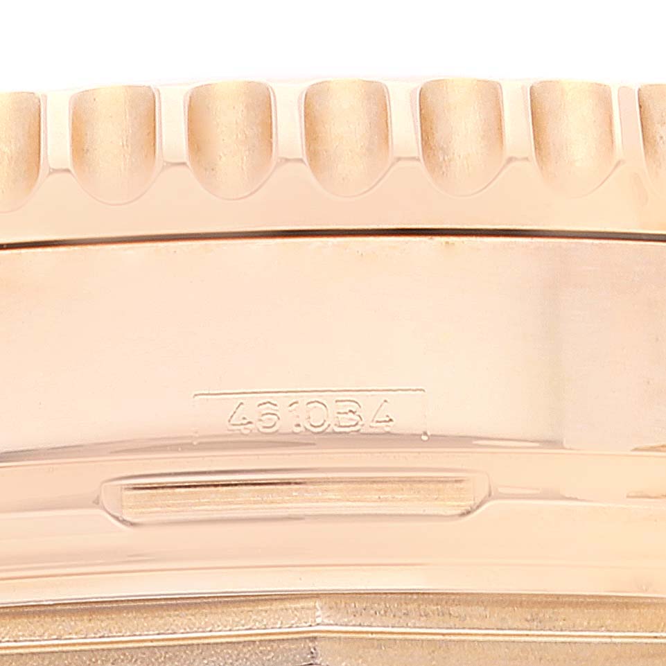 Close-up of the watch case side of a Breitling Navitimer RB0121 Men's Rose Gold Black Dial RB0121 Men's Rose Gold Black Dial, showing a portion of the bezel and a serial number.