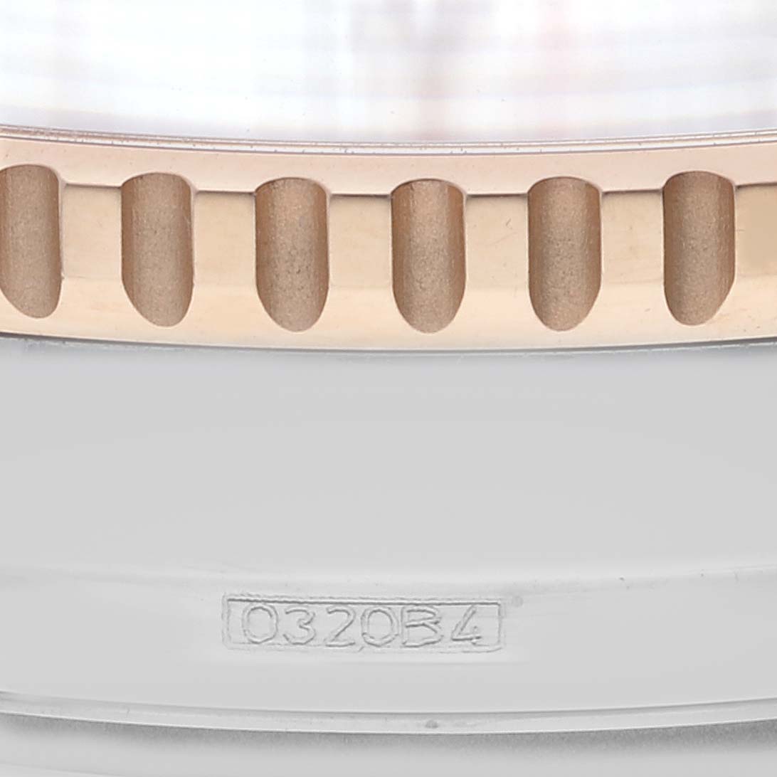 This close-up image of the Breitling Navitimer U13324211B1X1 Men
s Steel and Gold (two tone) Black Dial U13324211B1X1 Men
s Steel and Gold (two tone) Black Dial watch shows the bezel and part of the side of the case featuring a serial number.