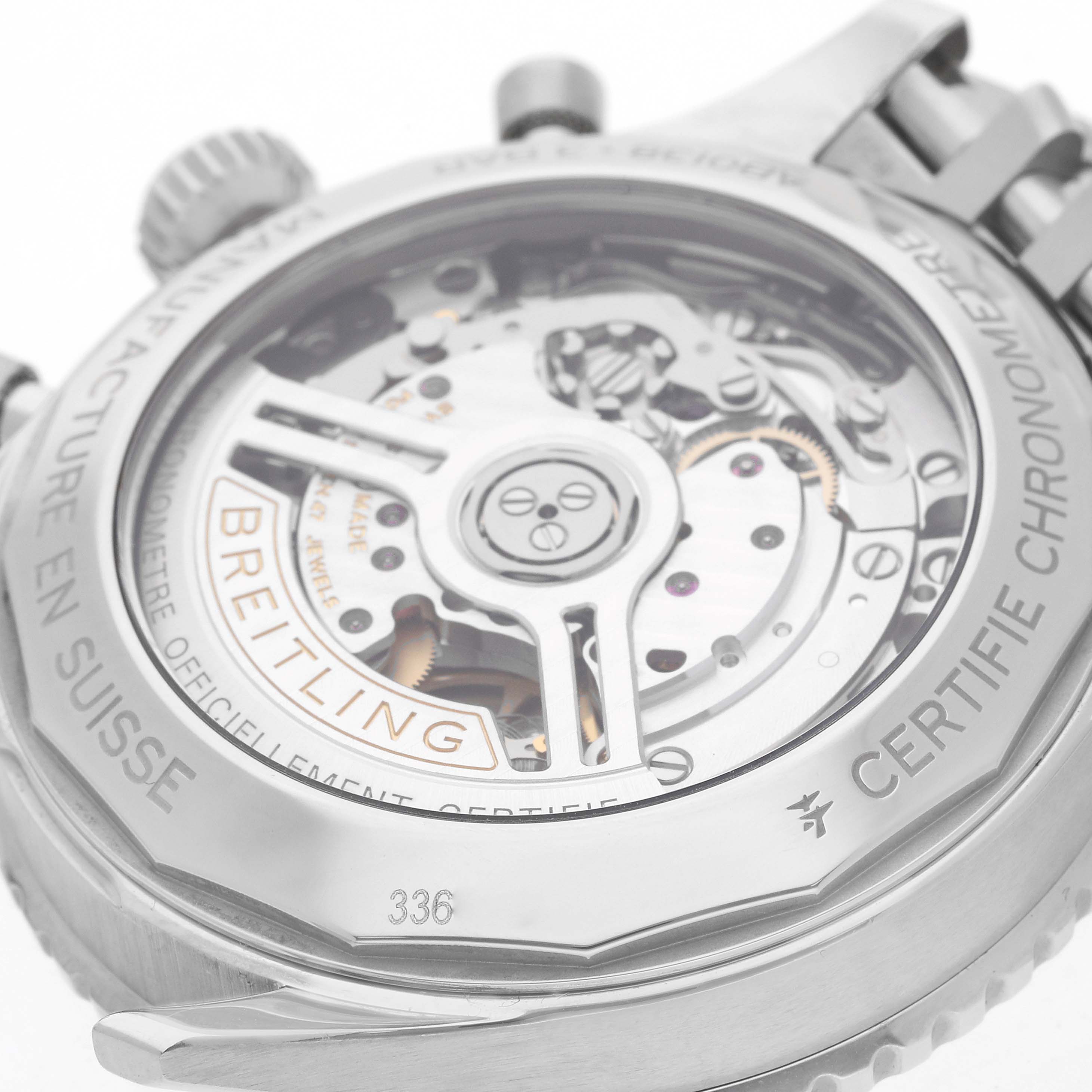 The image shows the back of a Breitling Navitimer AB0138 Men
s Stainless Steel Pink Dial watch, highlighting its intricate movement through a transparent case back.