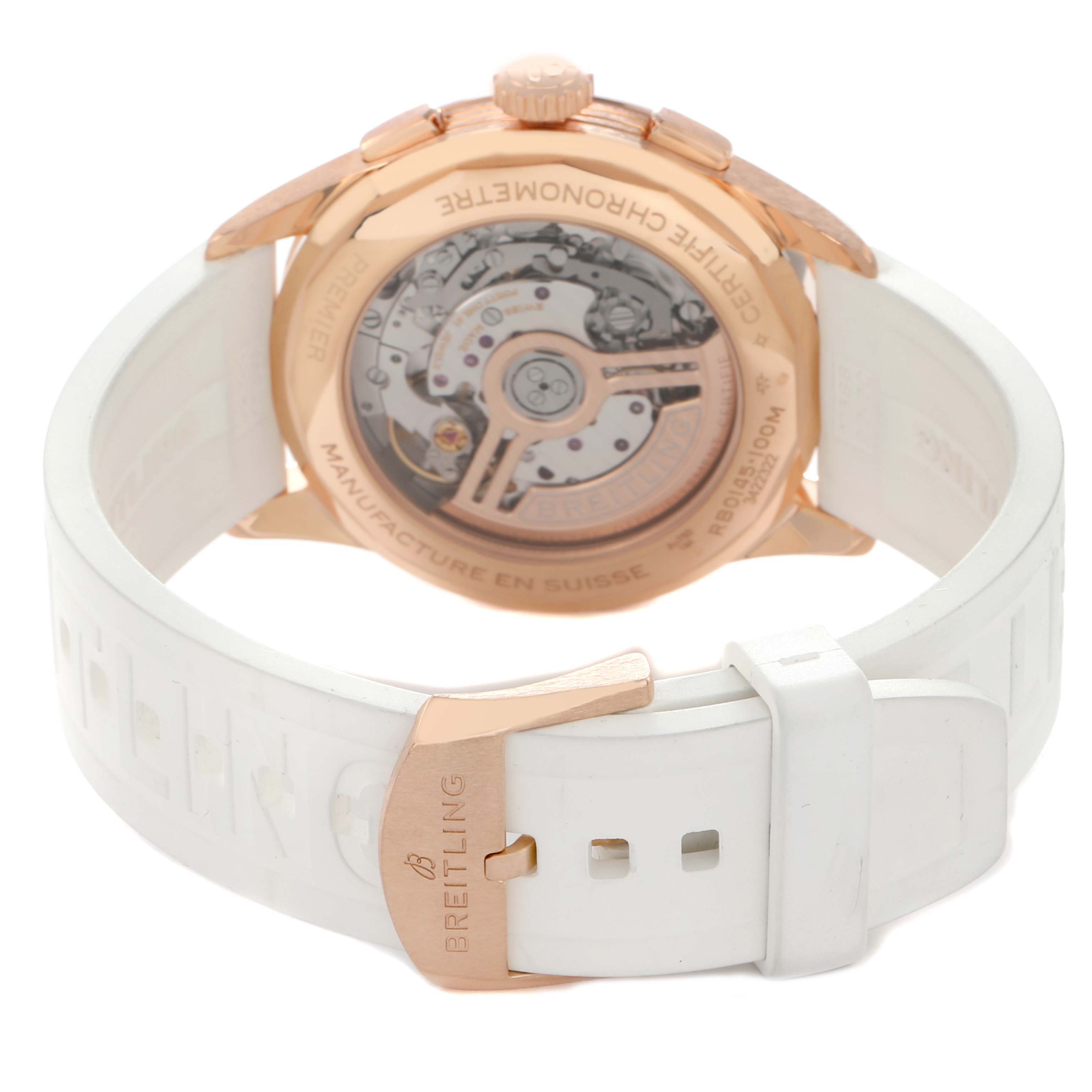 The Breitling Premier RB0145371G1R1 Men
s Rose Gold White Dial model is shown from the back, highlighting the movement, case back, and part of the white strap with the clasp.