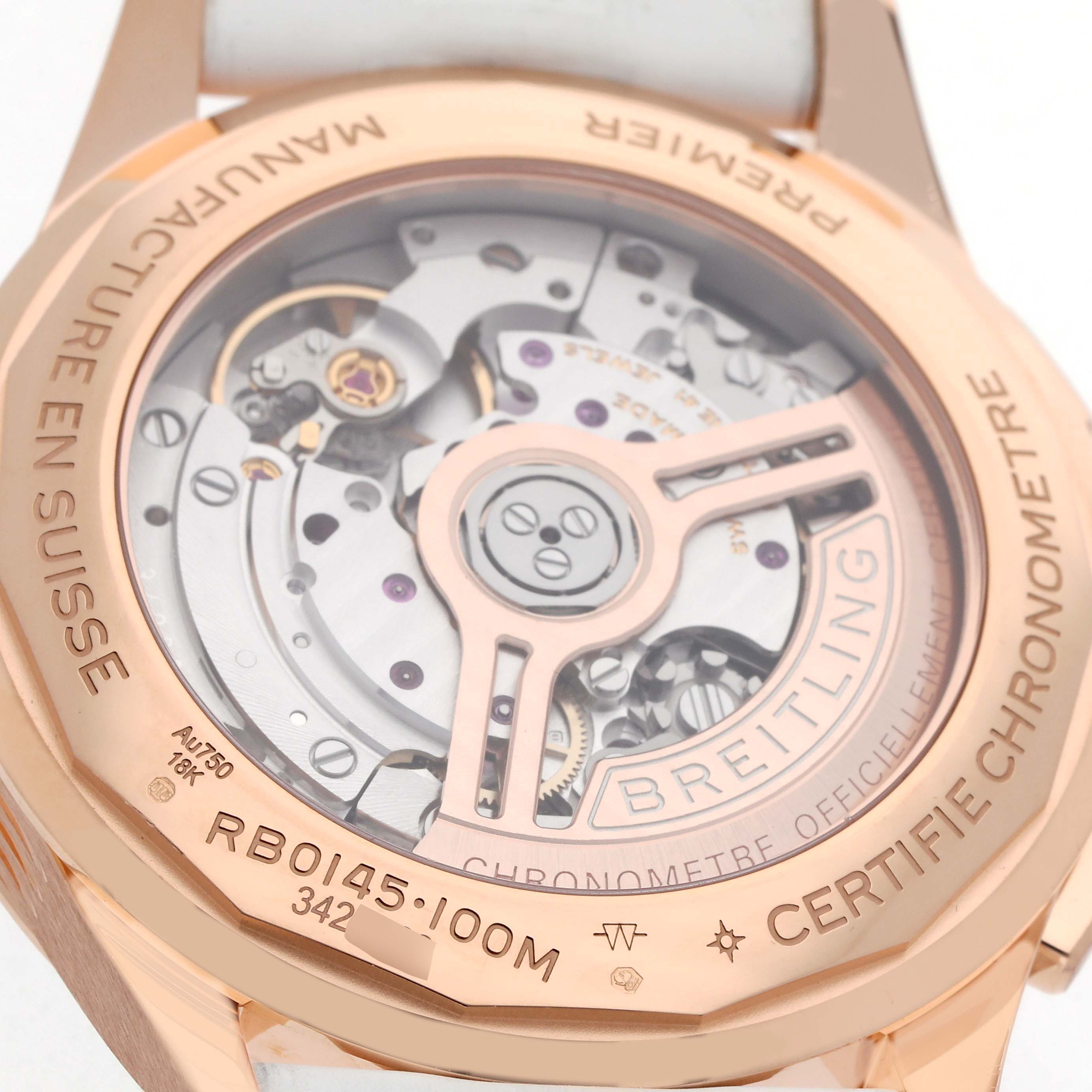 The image shows the back of a Breitling Premier RB0145371G1R1 Men
s Rose Gold White Dial watch, highlighting the intricacies of its movement and rotor.