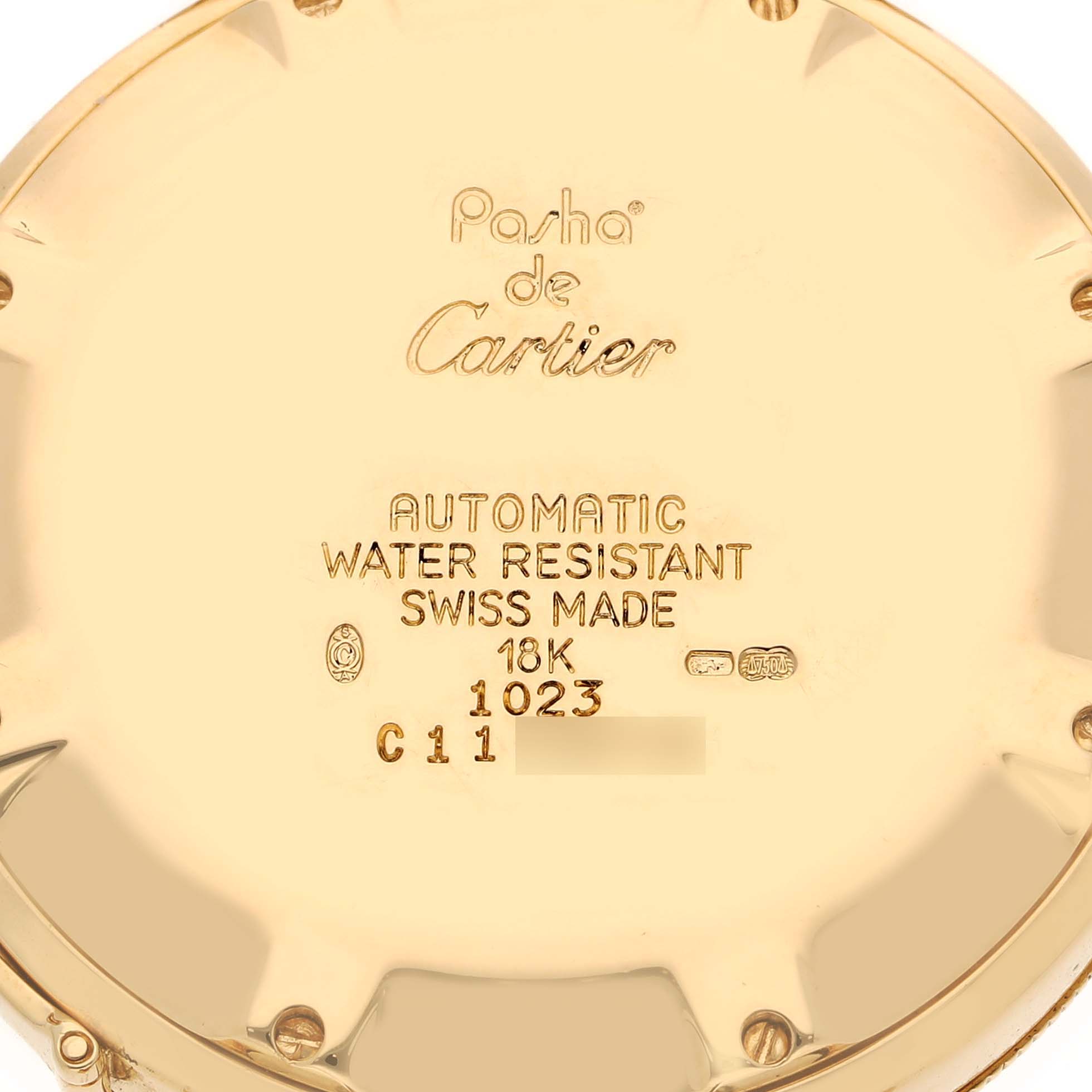 The image shows the back case of a Cartier Pasha 1023 Men's Yellow Gold Silver Dial 1023 Men's Yellow Gold Silver Dial watch, highlighting its engravings and material details.