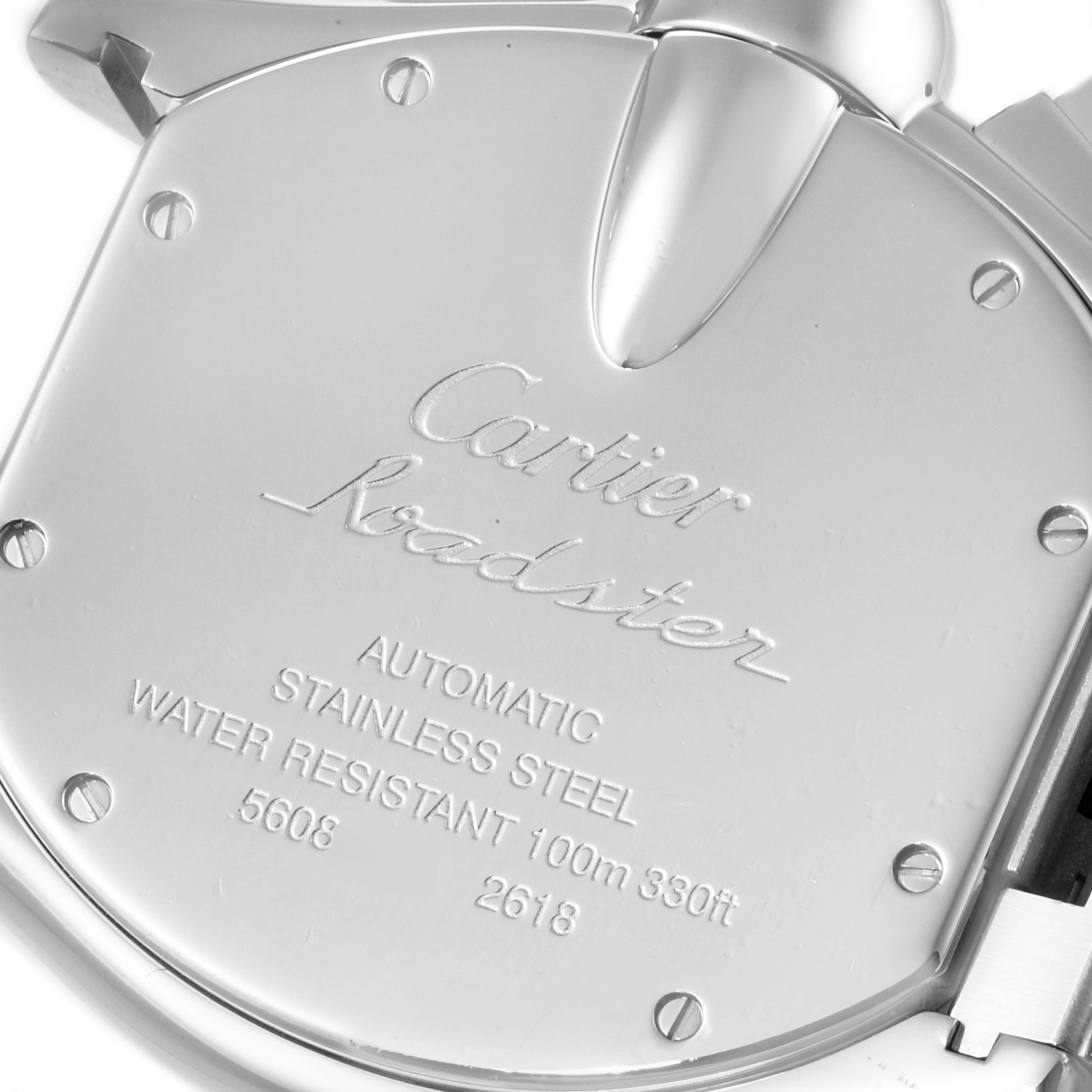 The image shows the back case of a Cartier Roadster W62019X6 Men
s Stainless Steel Silver Dial W62019X6 Men
s Stainless Steel Silver Dial watch with engraved details and part of the clasp.