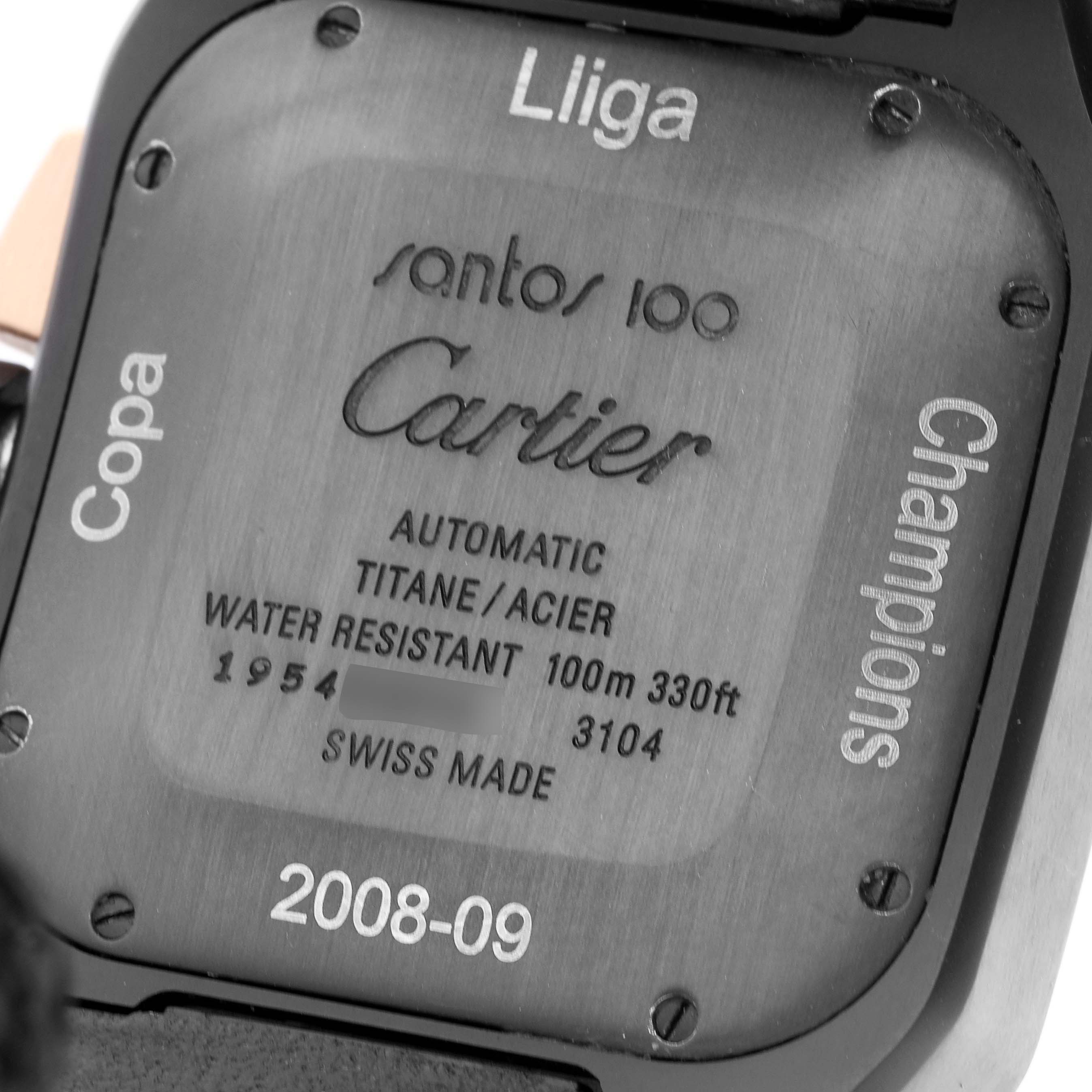 The image shows the back case of a Cartier Santos W2020004 Men
s Titanium Black Dial 100 watch, highlighting its inscriptions and specifications.