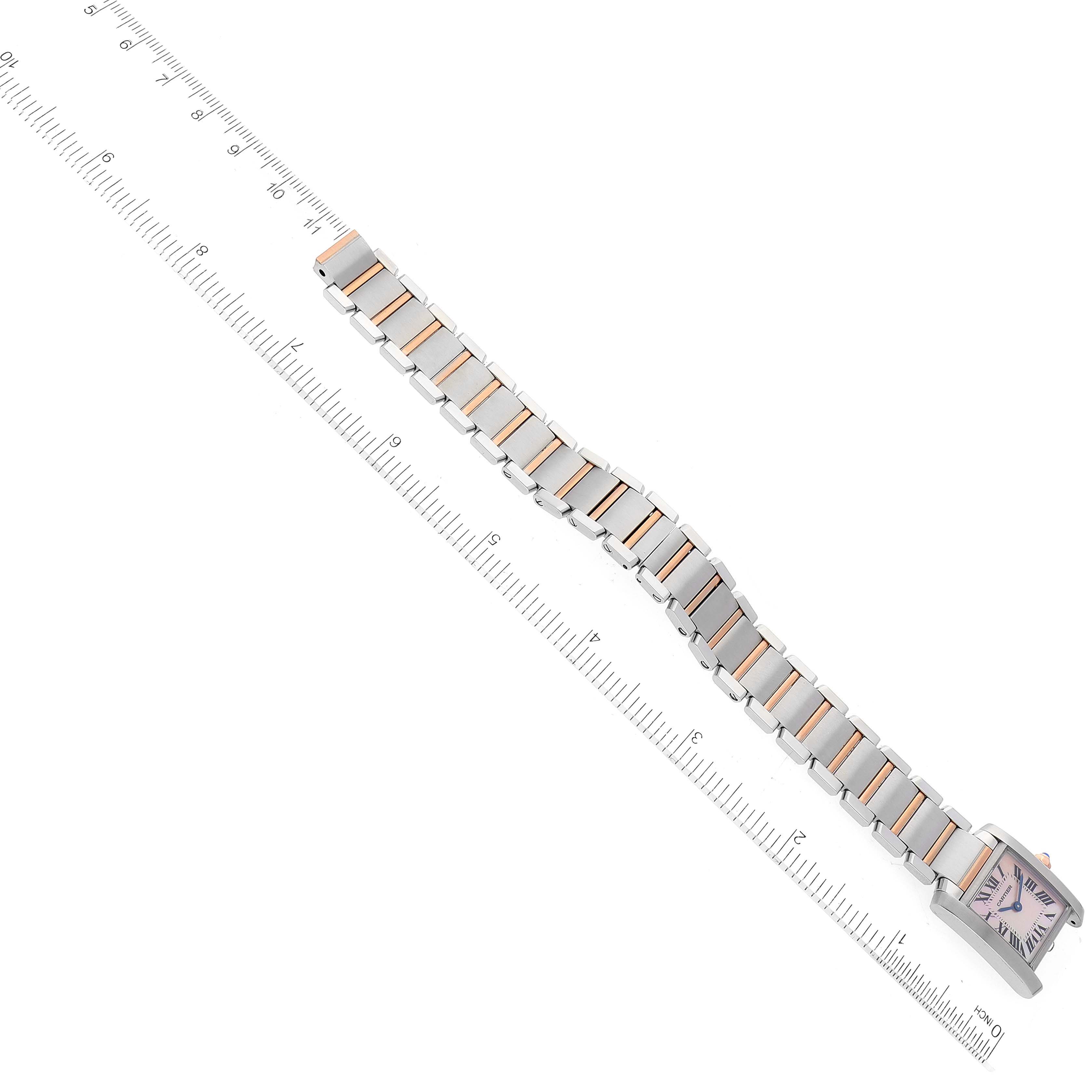 The image shows a Cartier Tank Française watch with its bracelet fully extended alongside a ruler for measurement.