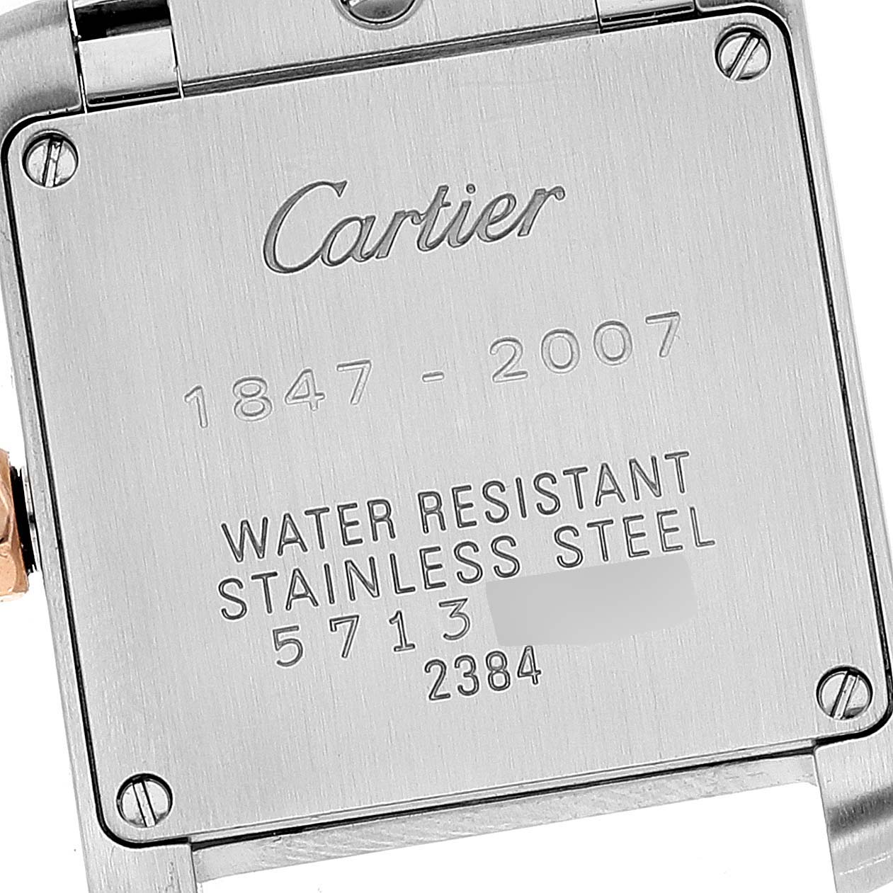 This image shows the back case of the Cartier Tank Française watch, highlighting its engravings and screws.