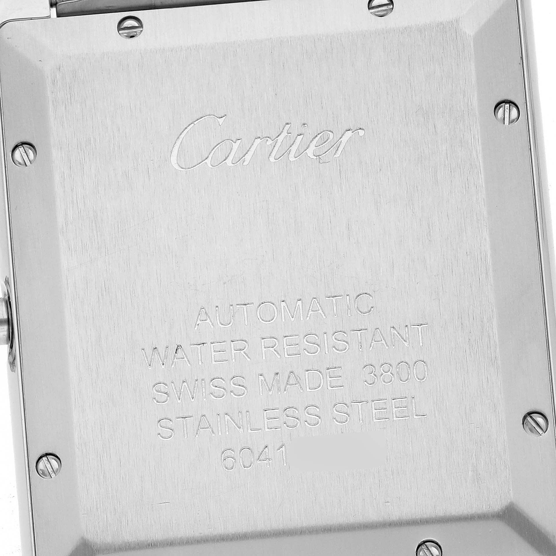 The image shows the back of a Cartier Tank Solo W5200028 Men's Stainless Steel Silver Dial W5200028 Men's Stainless Steel Silver Dial watch with engraved details and screws visible.