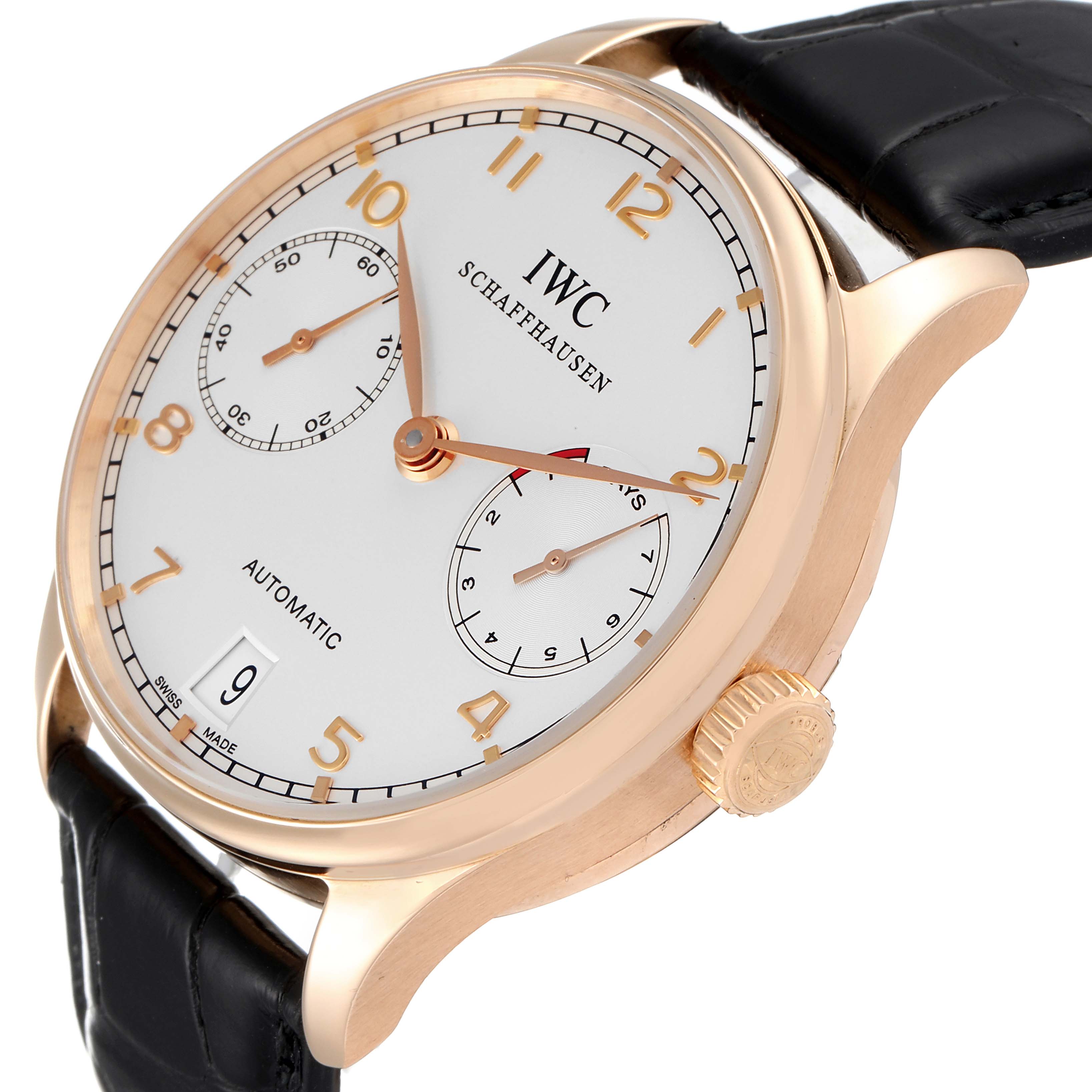 The image shows a close-up side angle of the IWC Portuguese IW500004 Men's Rose Gold Silver Dial IW500004 Men's Rose Gold Silver Dial watch, featuring its dial, crown, and leather strap.