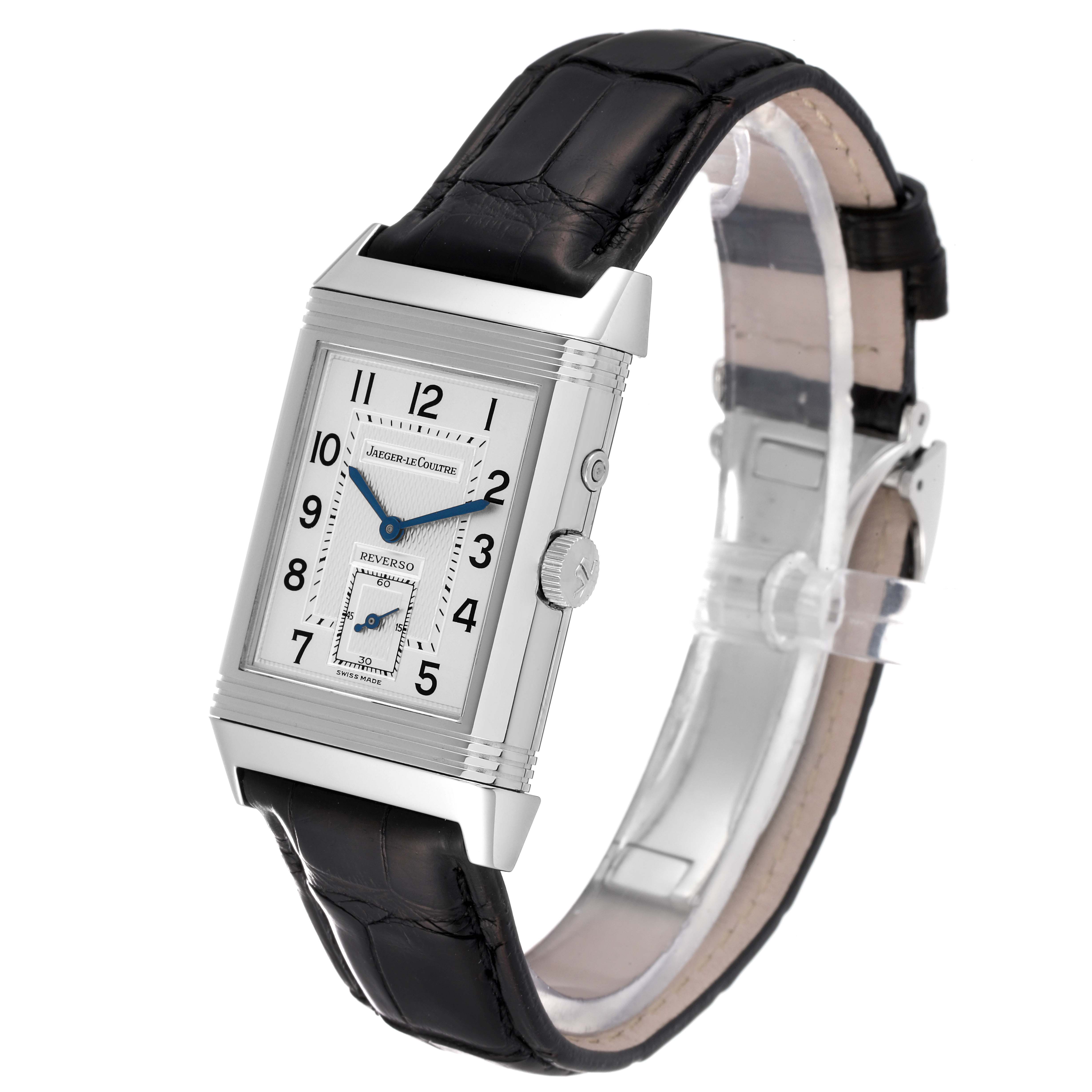The image shows a Jaeger-LeCoultre Reverso watch with a rectangular face, blue hands, a sub-dial, and a black leather strap at a slight side angle.