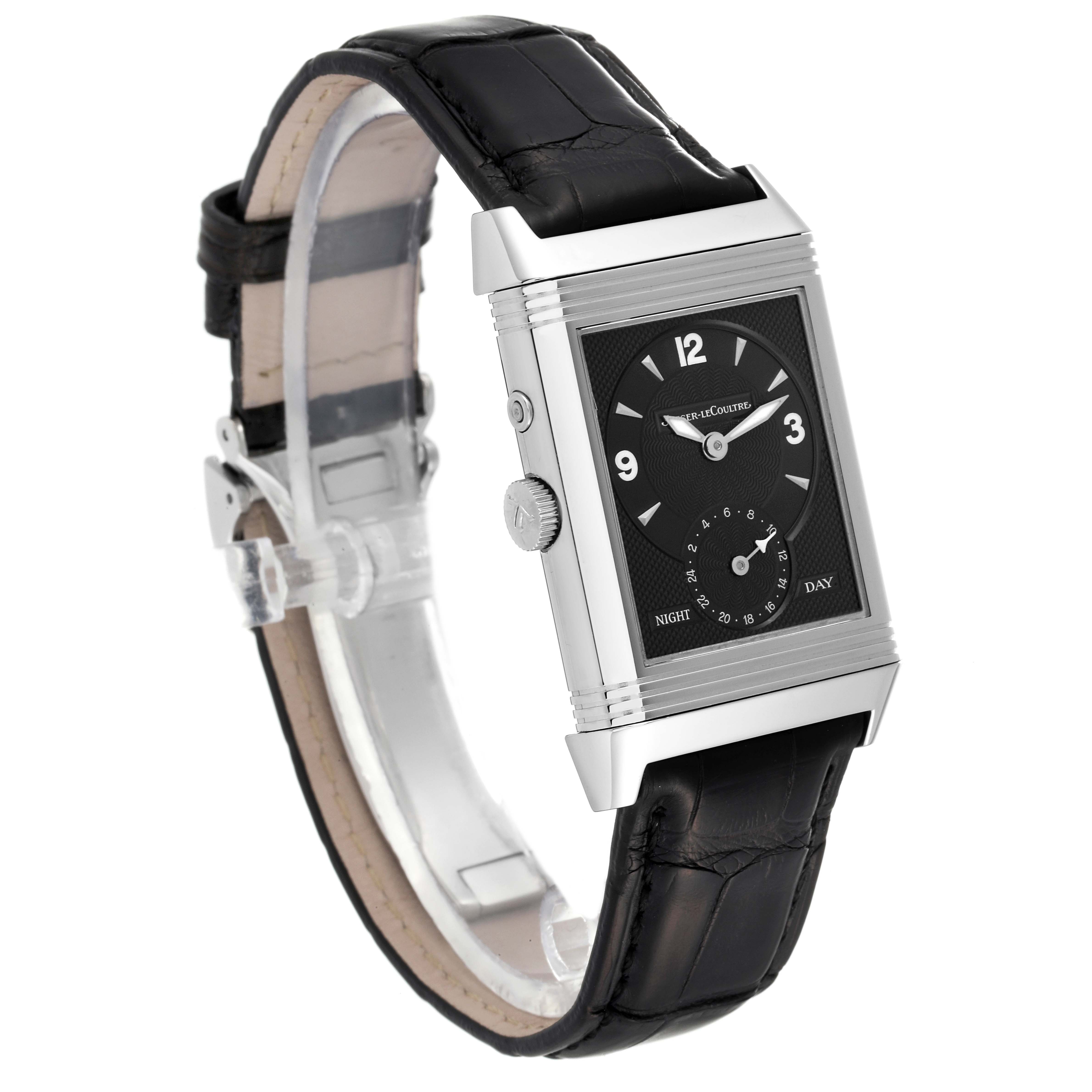 The Jaeger-LeCoultre Reverso watch is shown at a slight angle, displaying the rectangular face, crown, and black leather strap.