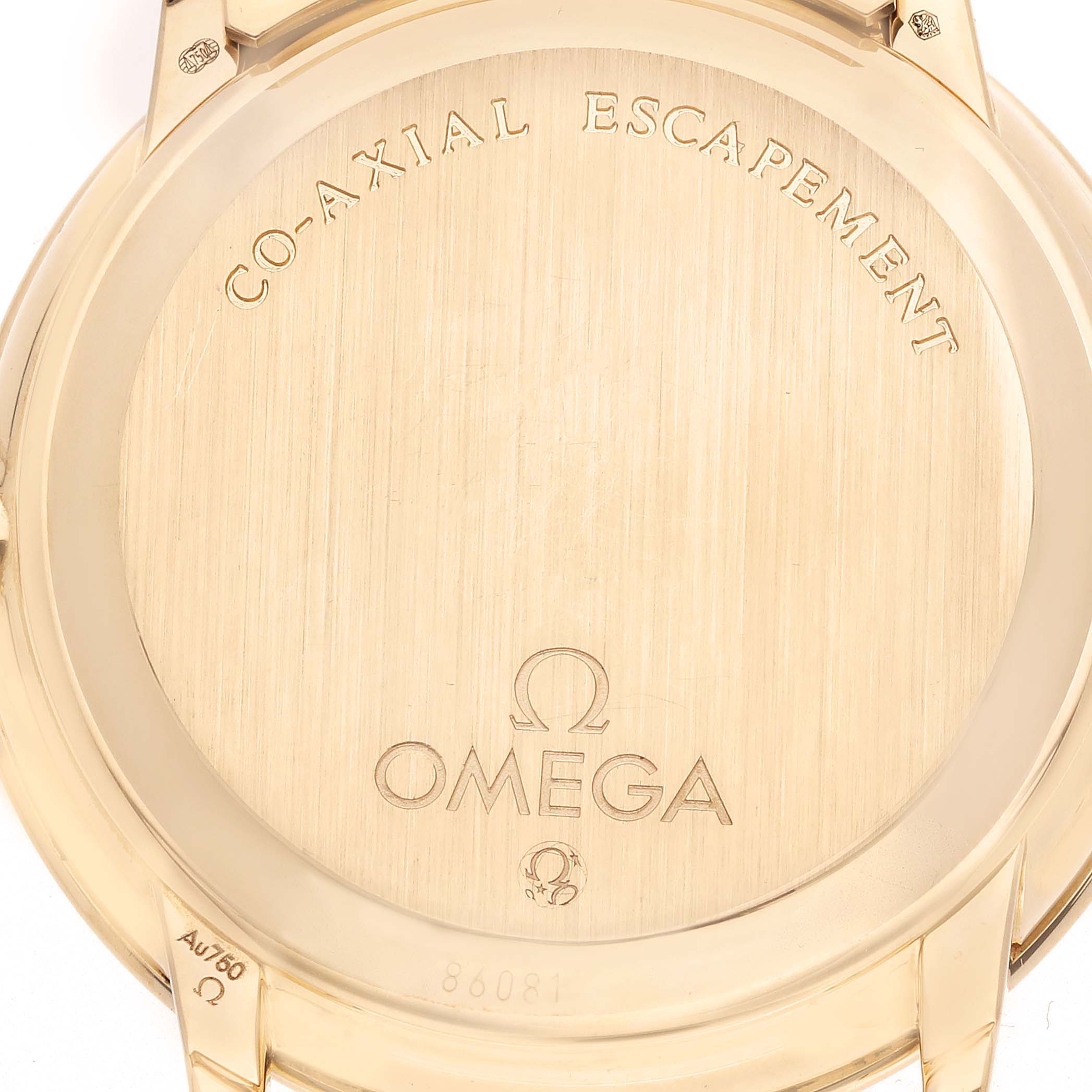 The image shows the back case of the Omega De Ville 413.58.37.20.58.001 Men's Yellow Gold Champagne Dial watch, highlighting the "Co-Axial Escapement" engraving.