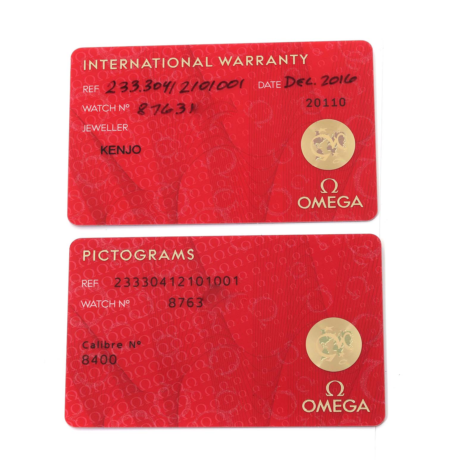 The image shows two red cards, an International Warranty card and a Pictograms card for an Omega Seamaster 233.30.41.21.01.001 Men
s Stainless Steel Black Dial 233.30.41.21.01.001 Men
s Stainless Steel Black Dial watch.